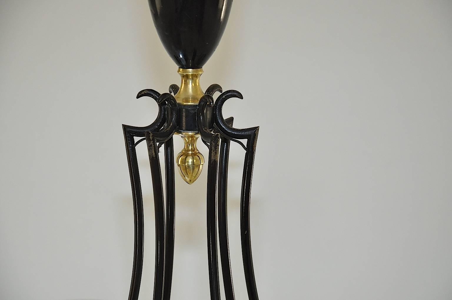 This magnificent chandelier is perfect for a decoration with 1940 style objects. This is a French chandelier done in the neoclassical tradition.
The materials are brass and black lacquered metal, the shades are in glass, forming 