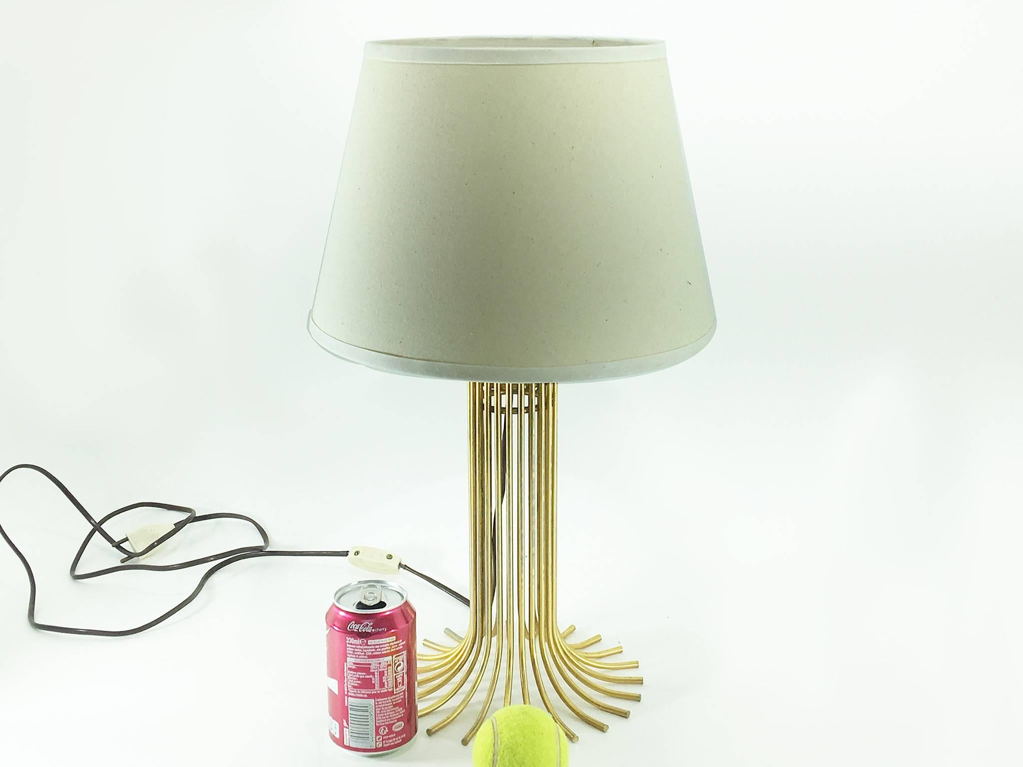 Table lamp in gilt metal, in the style of Jean Royère.