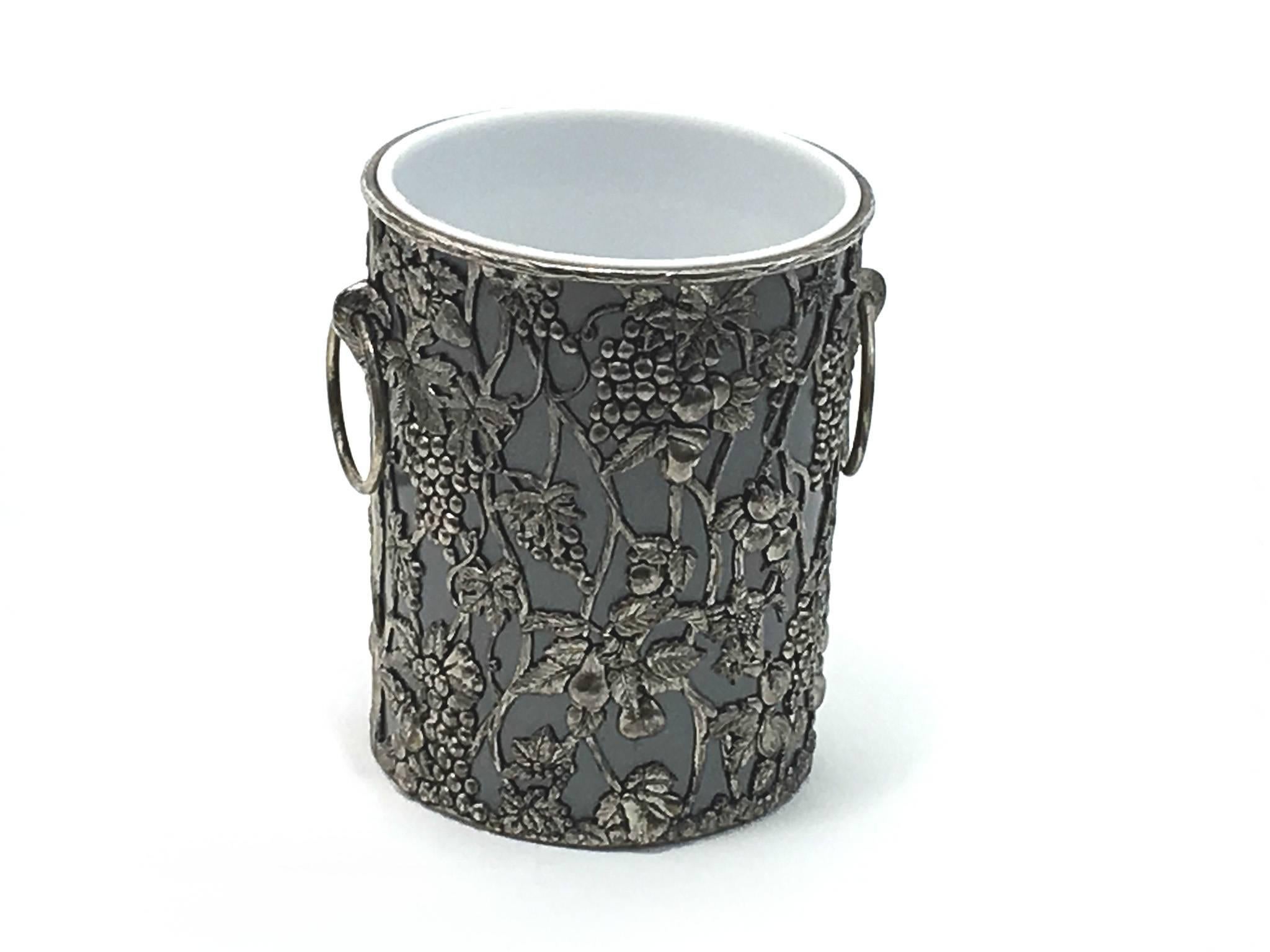 Champagne bucket with silvered colored floral decor frame.
Champagne cooler.
Ice bucket.