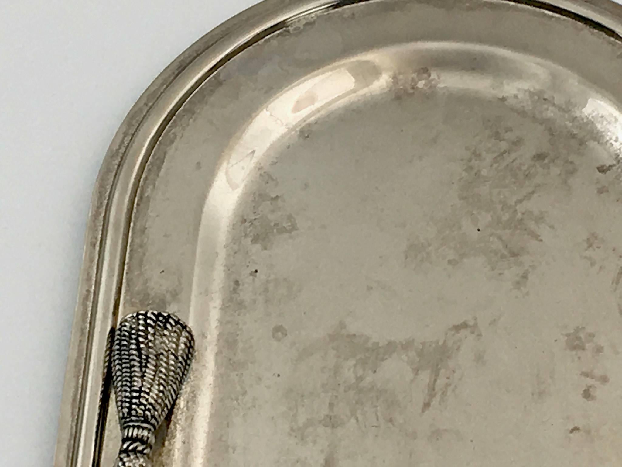 Silvered metal toast holder.