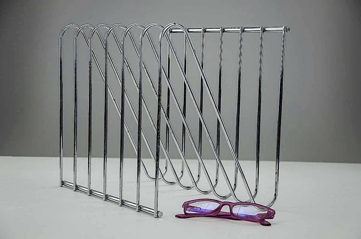A French midcentury magazine holder from the 1970s, with Chromed Steel dividers, for many compartments to store books or magazines.. Modern accessory for any modern interior or office.
In good condition with nice patina on the Chromed pieces.
The