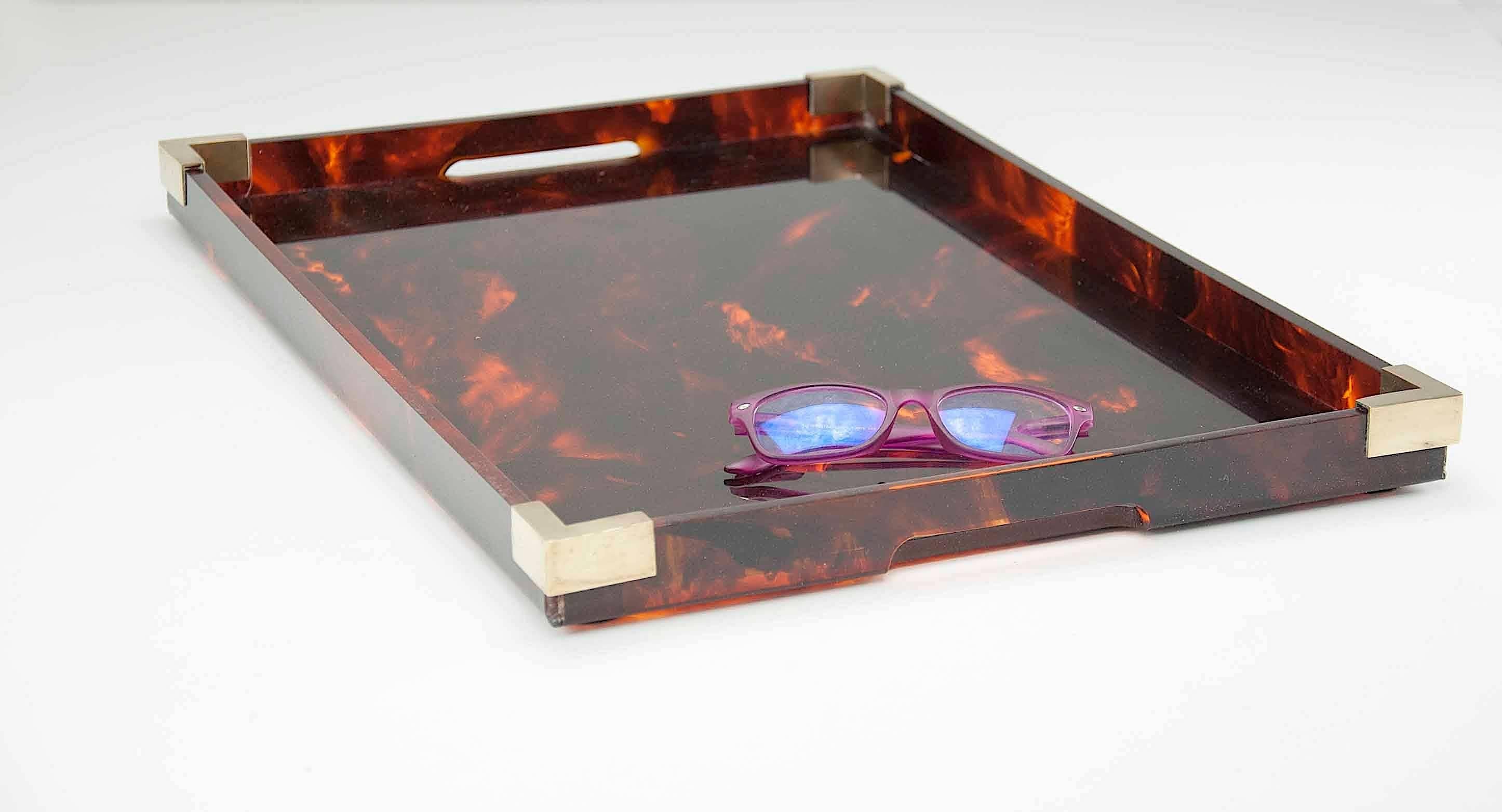 A Mid-Century Modernist serving tray platter attributed to Christian Dior Home Collection, circa 1960s. Large rectangular shape with Lucite in faux tortoise shell pattern and color and brass border.