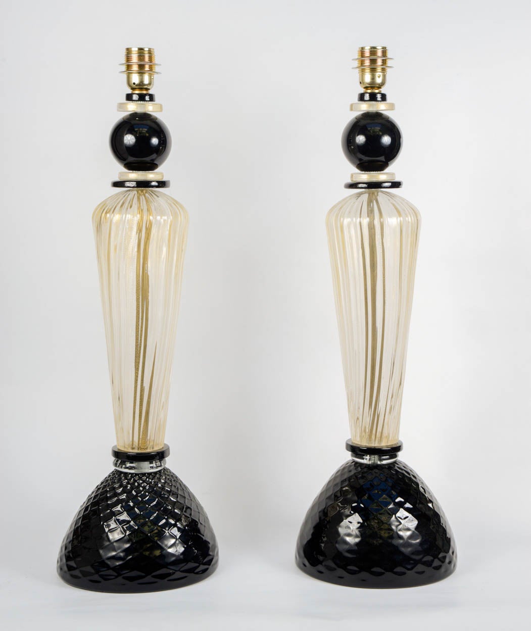 Pair of table lamps in gold and black Murano glass.