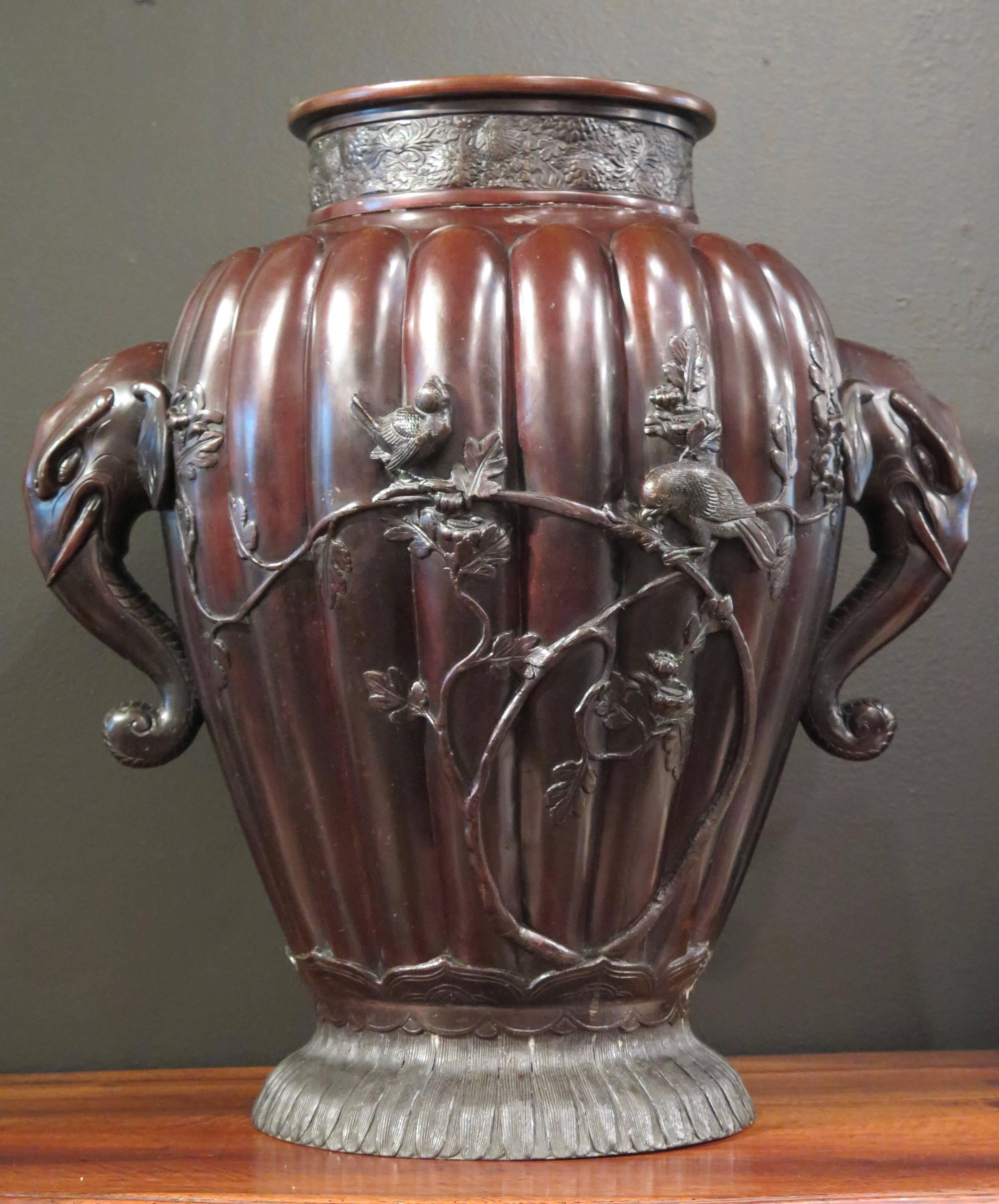 A very large Meiji period bronze vase, possibly for temple use, with high relief design and elephant head handles, late 19th century, Japan. 

Of baluster form and unusual size, yet still retaining elegant proportions, the lobed body rising from a