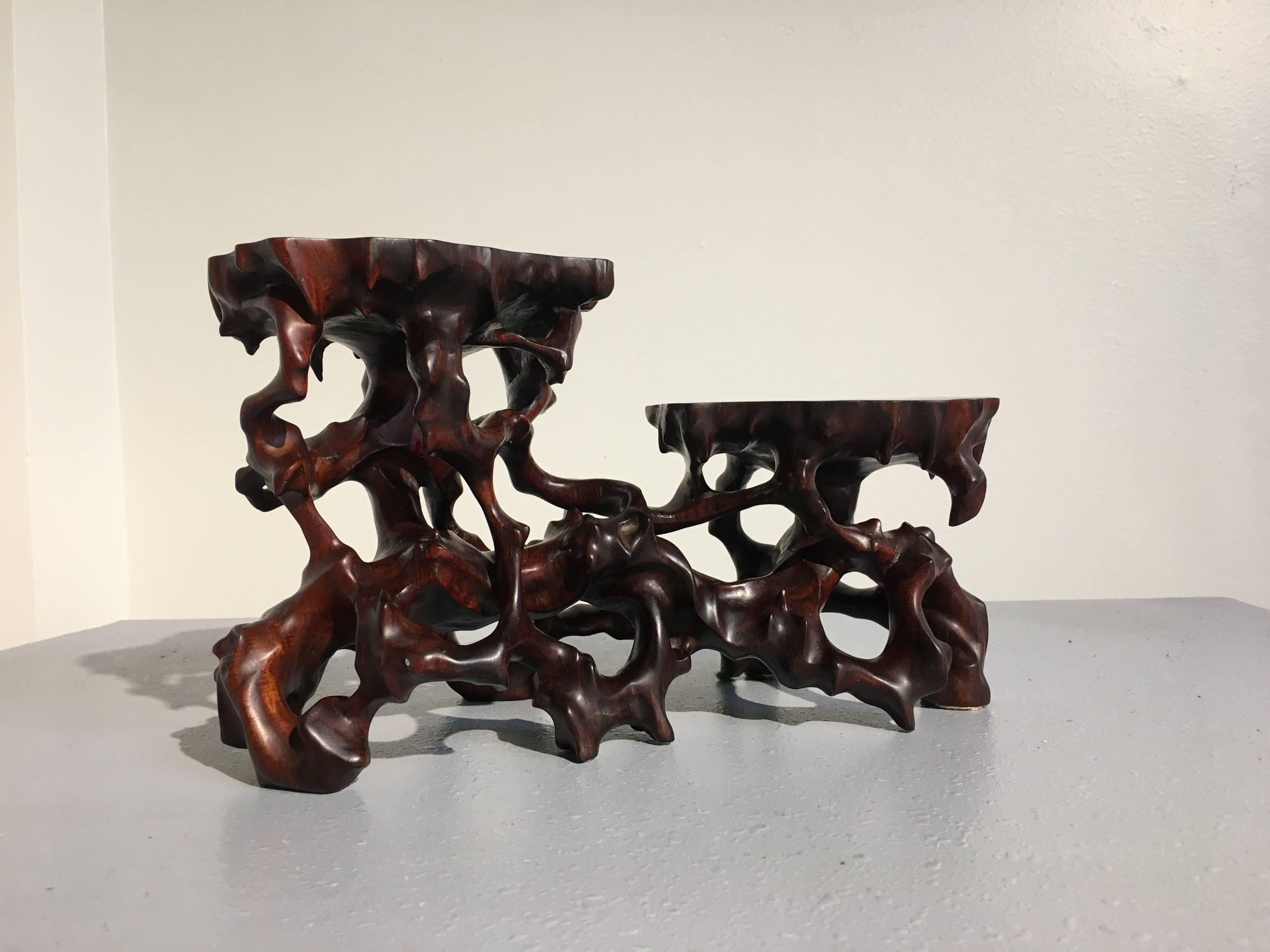 A dramatic and evocative, naturalistic Chinese carved hardwood double display stand.

Used by Chinese scholars to display treasured objects, this display stand has been carved of hongmu (rosewood) to imitate a natural gnarled and intertwined