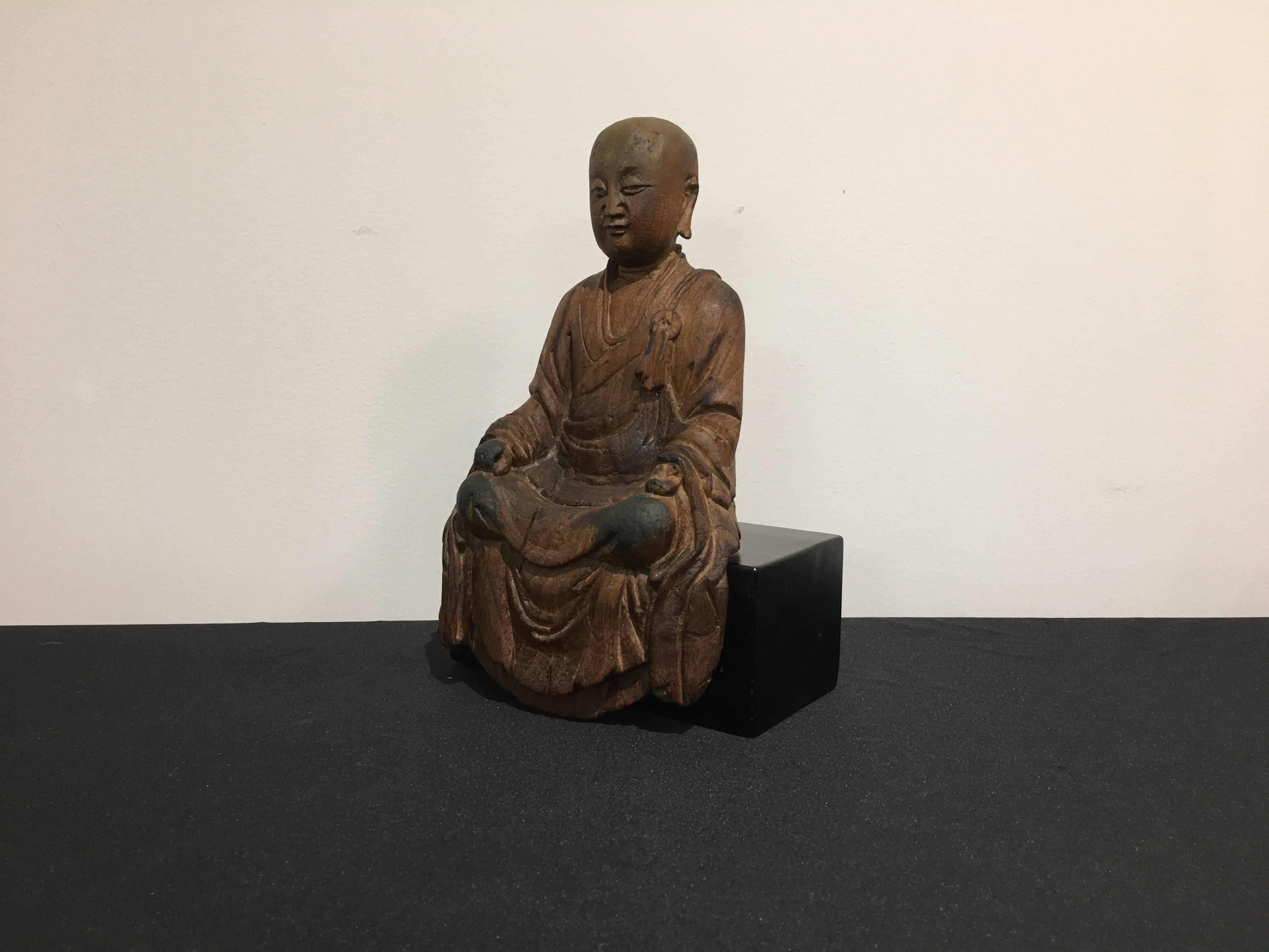 A charming and serene Chinese carved sandalwood figure of the bodhisattva Ksitigarbha, Yuan Dynasty, 14th century, China. 

Carved for a single piece of fragrant sandalwood, the bodhisattva is portrayed as monk is dressed in simple robes that fall