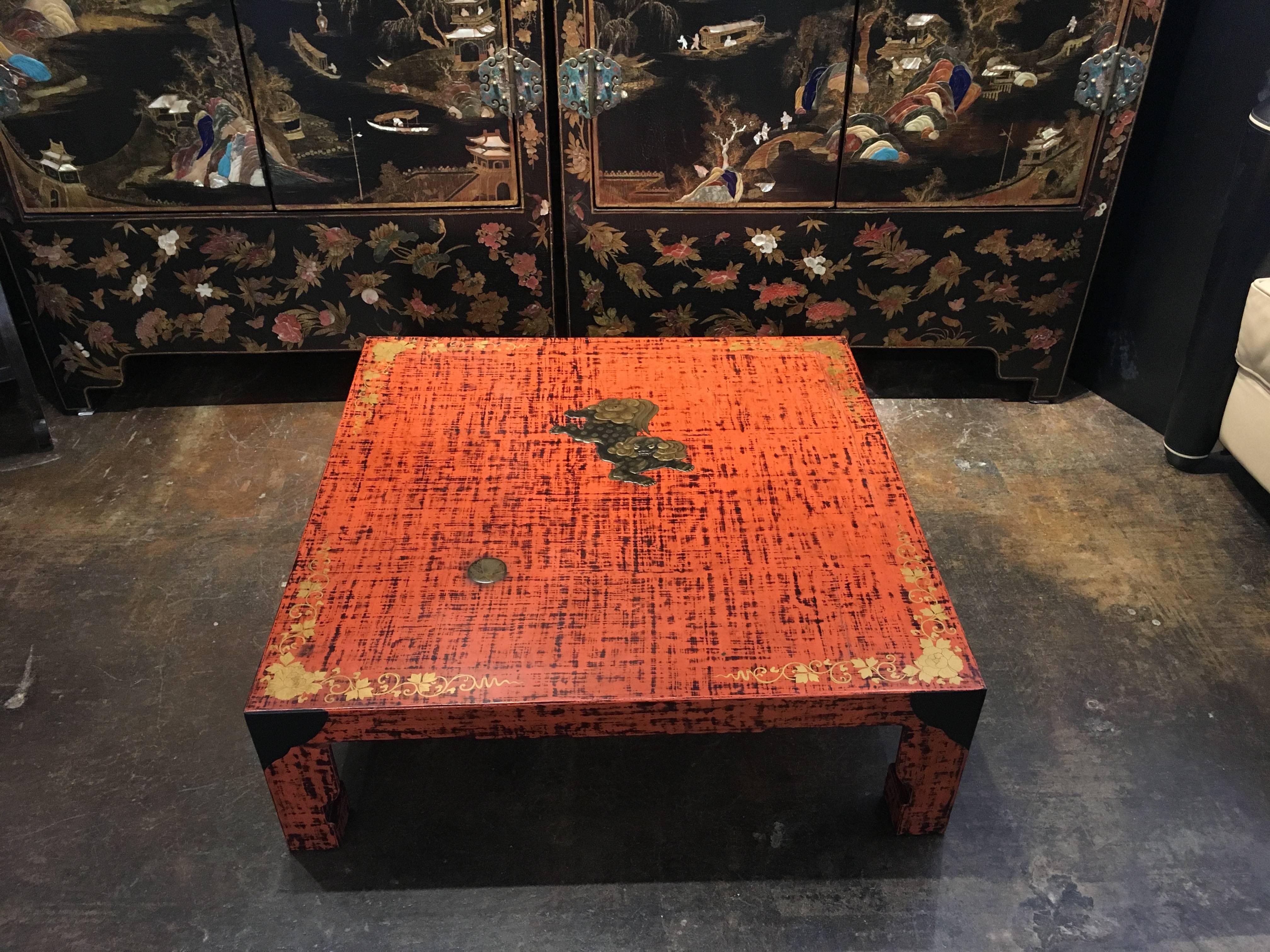 A stunning Japanese red and black negoro lacquer low, square table with a takamakie lacquer design of a shishi and ball, dated 3rd year of Showa, corresponding to 1928, and signed Katsunari. 
The table covered in a beautiful negoro lacquer of