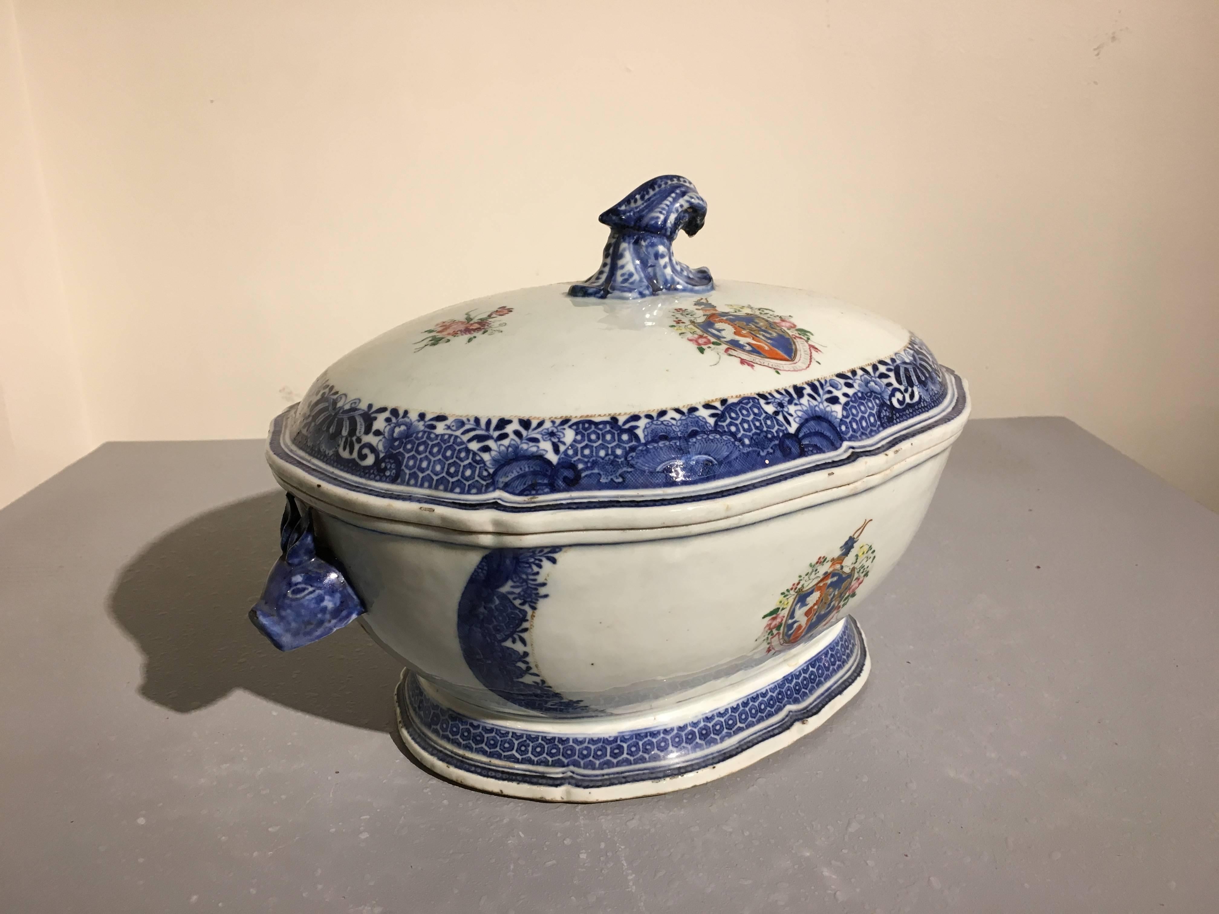 A rare Chinese export armorial tureen decorated in both underglaze blue and white and overglaze famille rose enamels. The tureen of typical form, with rabbit head handles to the body, and a squash stem handle to the lid, all supported by a slightly