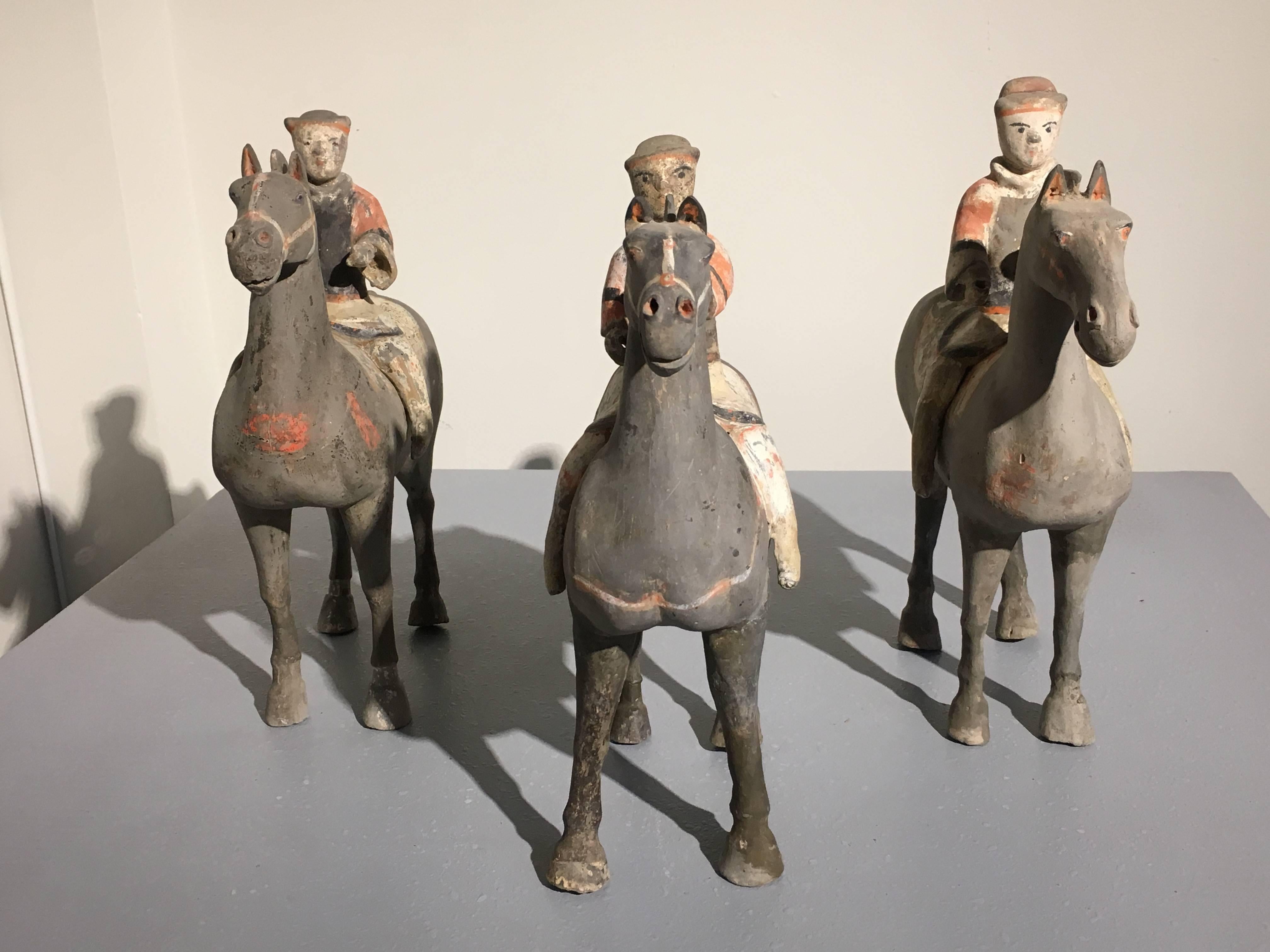 A charming set of three Han dynasty (220 BC-206 AD) painted pottery horse and riders. Representing soldiers, the figures are depicted in a riding stance, with painted armor. The horses stand foursquare with painted bridles and saddles.
Each TL
