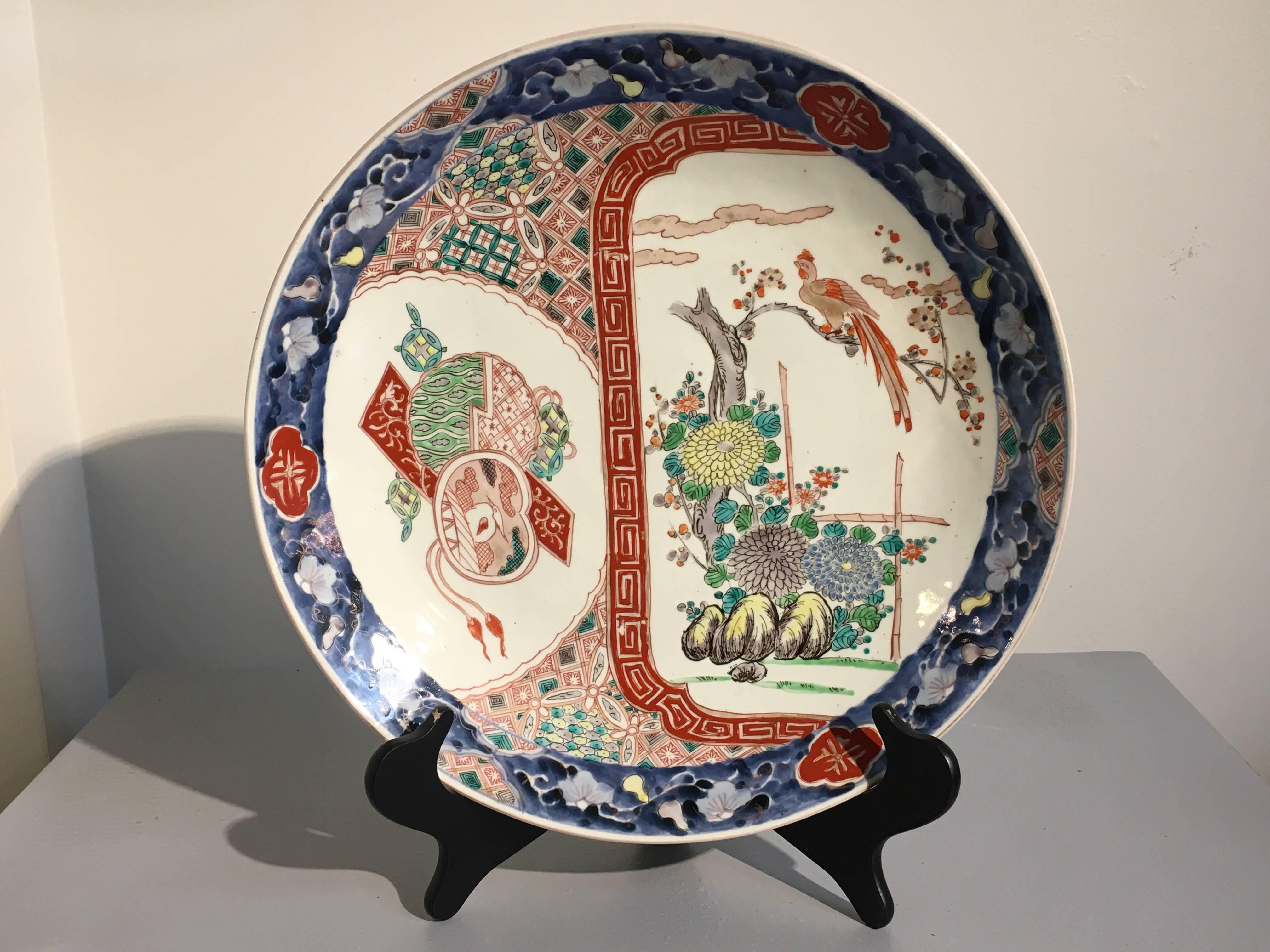 A nicely decorated Japanese Meiji Period Imari charger, late 19th century, Japan. 

The porcelain charger featuring a design of a hoho bird, or phoenix, perched in a garden setting, with rocks and blossoming flowers. The enamels painted in vibrant