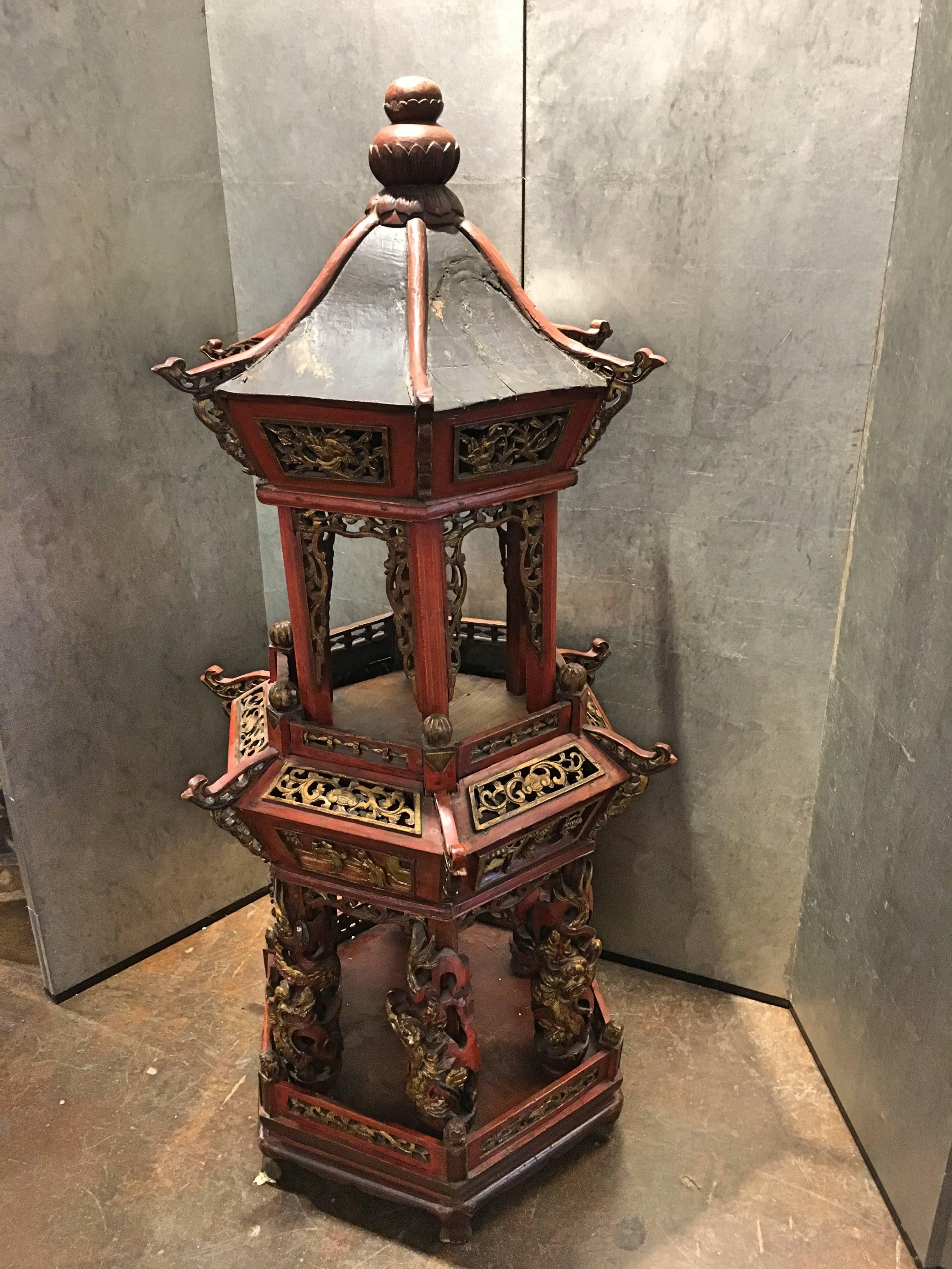 A large two-tiered hexagonal Chinese architectural model of a pagoda or pavilion, Qing Dynasty, late 19th century. 
The bottom tier with columns surrounded by writhing dragons that have been carved separately, and can rotate on the column. Scenes of