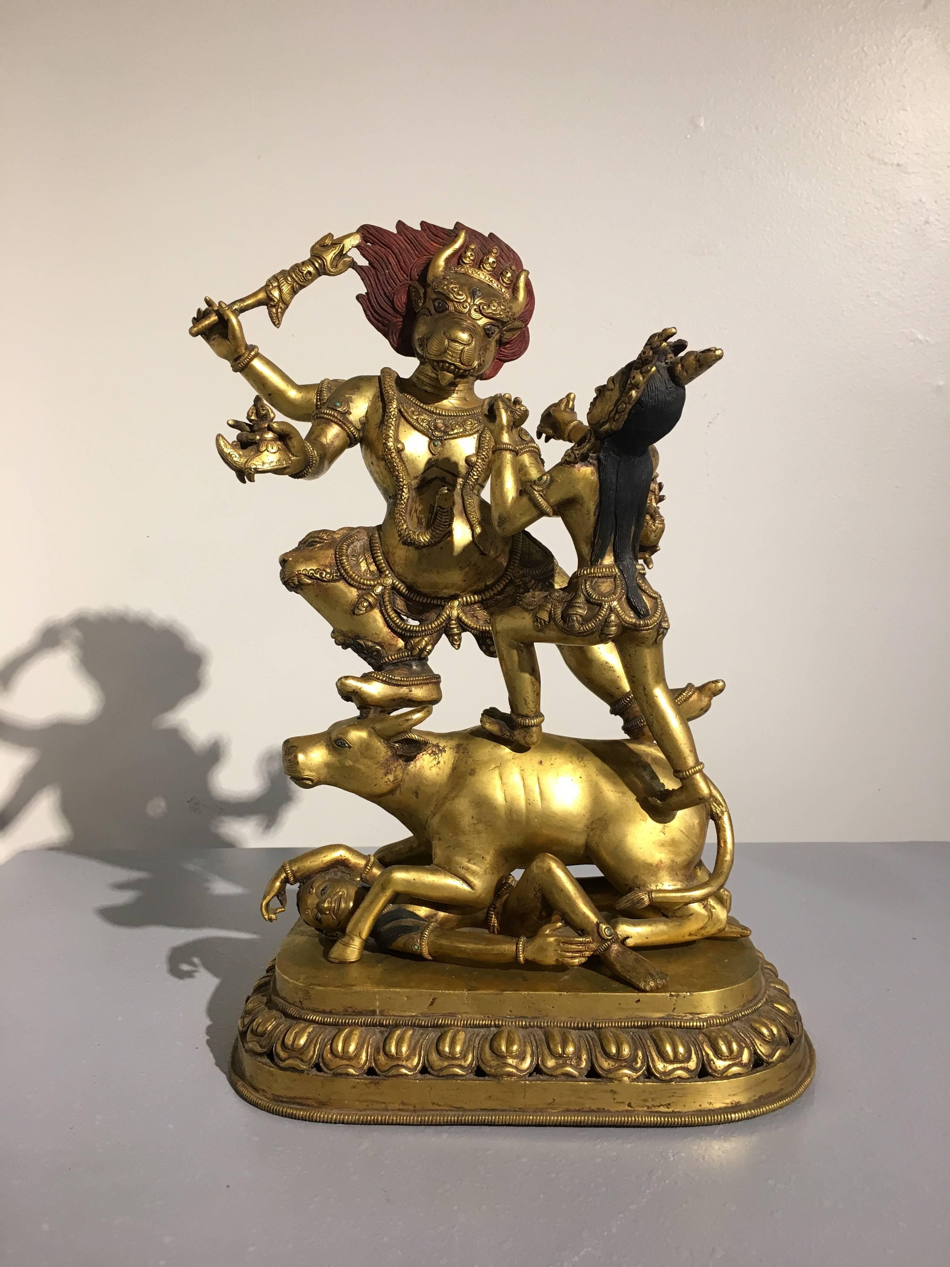 A large and impressive Nepalese tantric gilt bronze figure of the dikpala Yama and his sister, Yami, early to mid-20th century (1920s-1940s). 
Well cast and richly gilt, the buffalo headed dikpala (directional guardian) of the South stands upon the