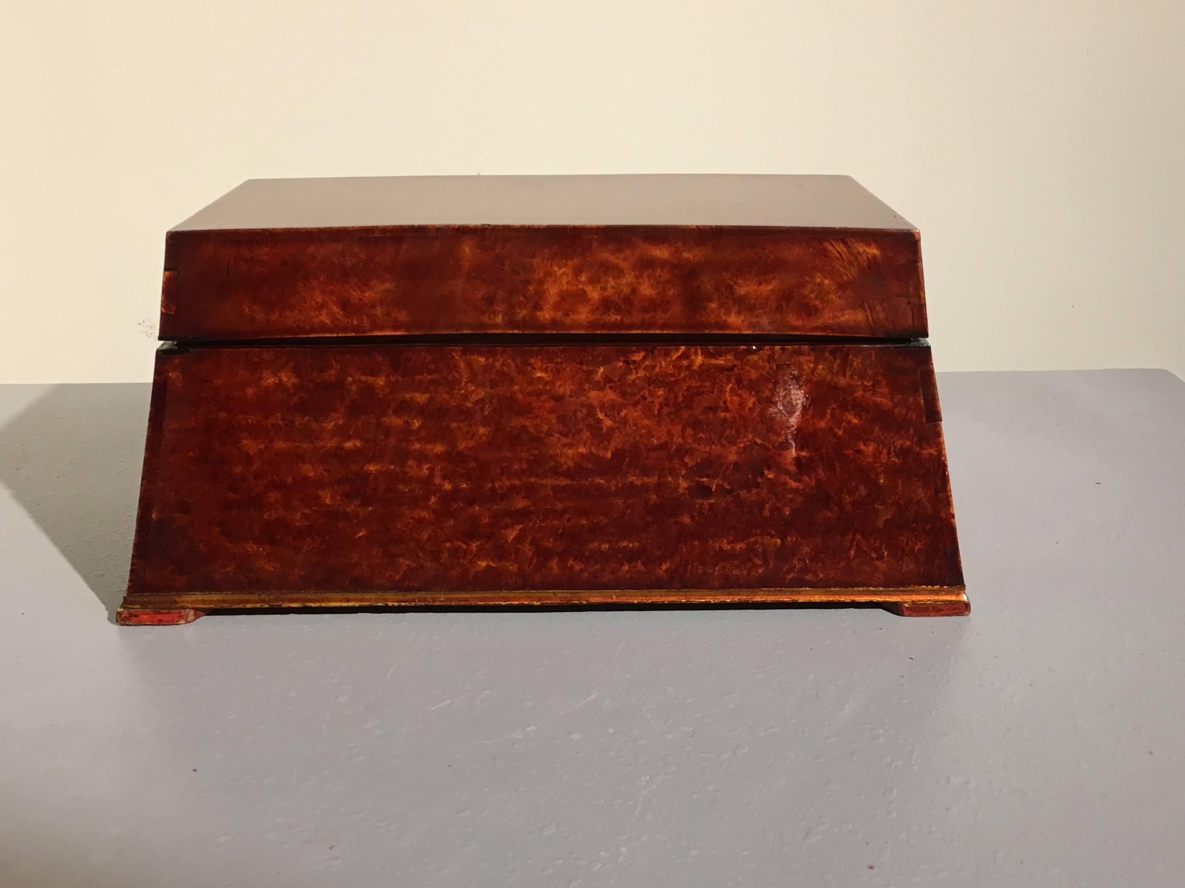 A striking Sumatran lacquered burl humidor box used for the storing implements related to betel nut chewing. The box, bearing a strong Art Deco feel (though predating it by several decades), is of trapezoidal shape and crafted of beautifully figured