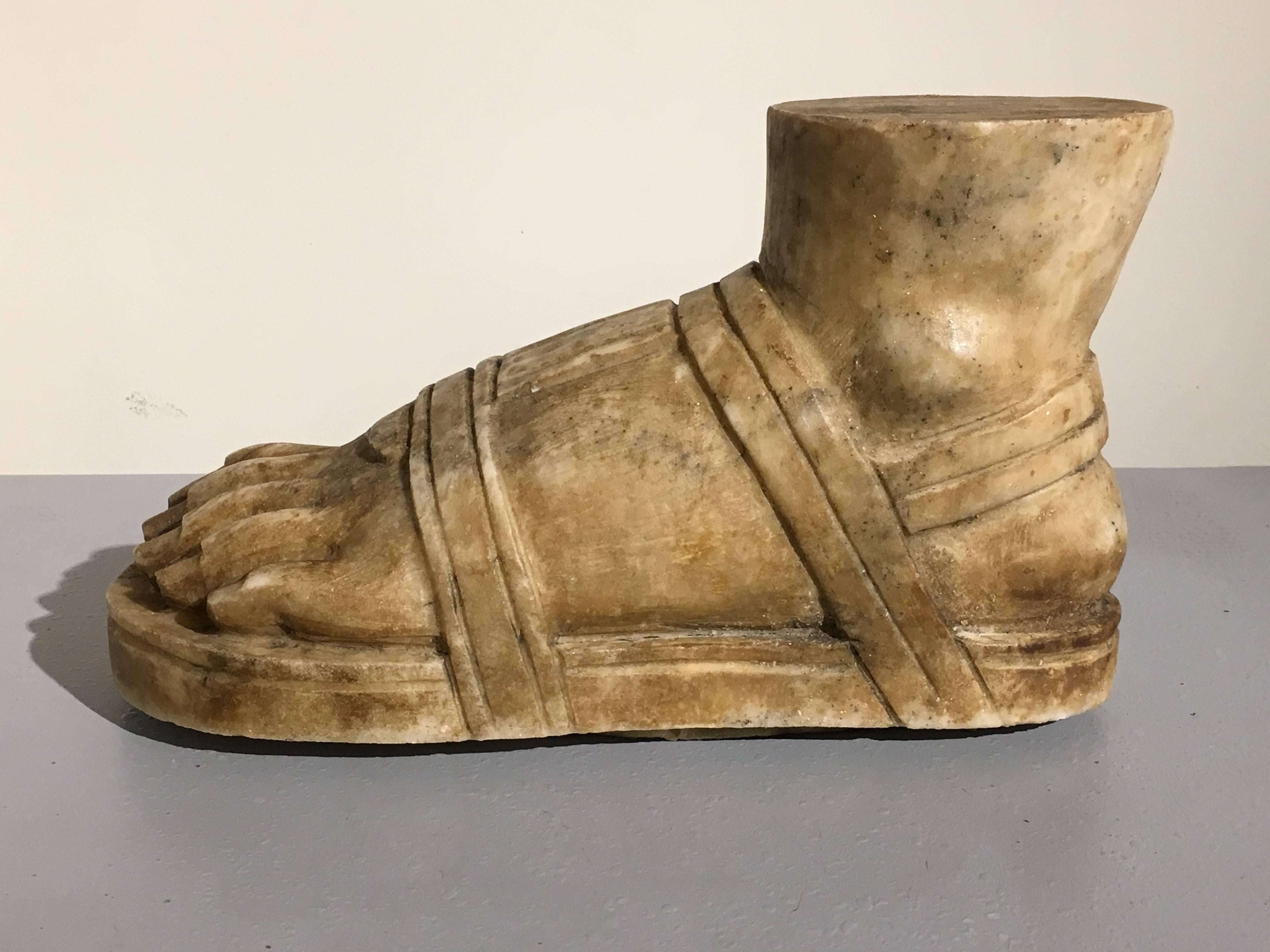 A larger than lifesize Roman model of a foot, carved from marble and based on the antique. The sandaled foot well carved with nice detail and patina, including well defined toes and toenails, as well as special attention paid to the sandal straps.