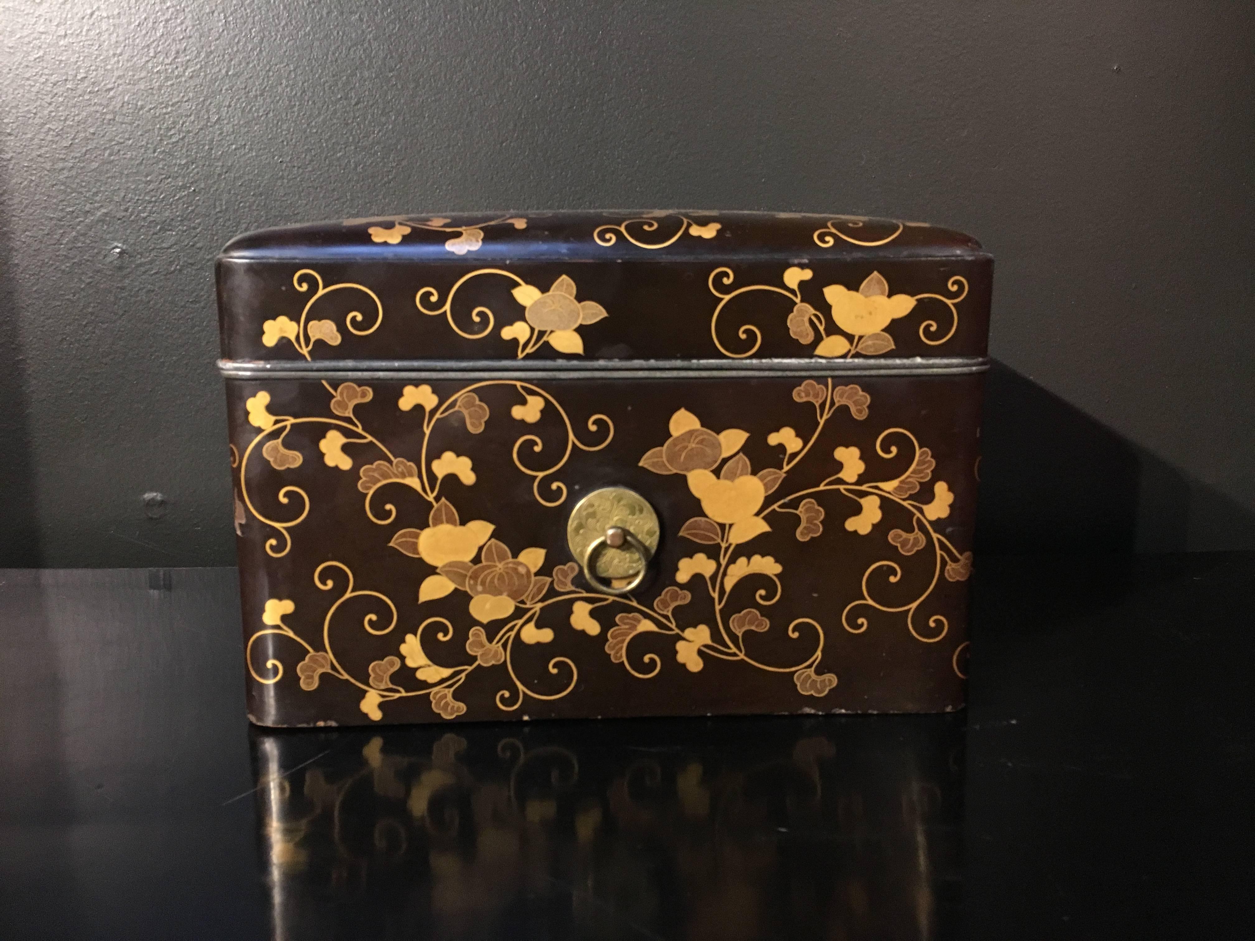 An elegant and beautiful Japanese black lacquer storage box with Maki-e decoration. Of rectangular form with a slightly domed lid, the exterior of the box decorated with scrolling vines of morning glory painted in the Maki-e technique. The interior