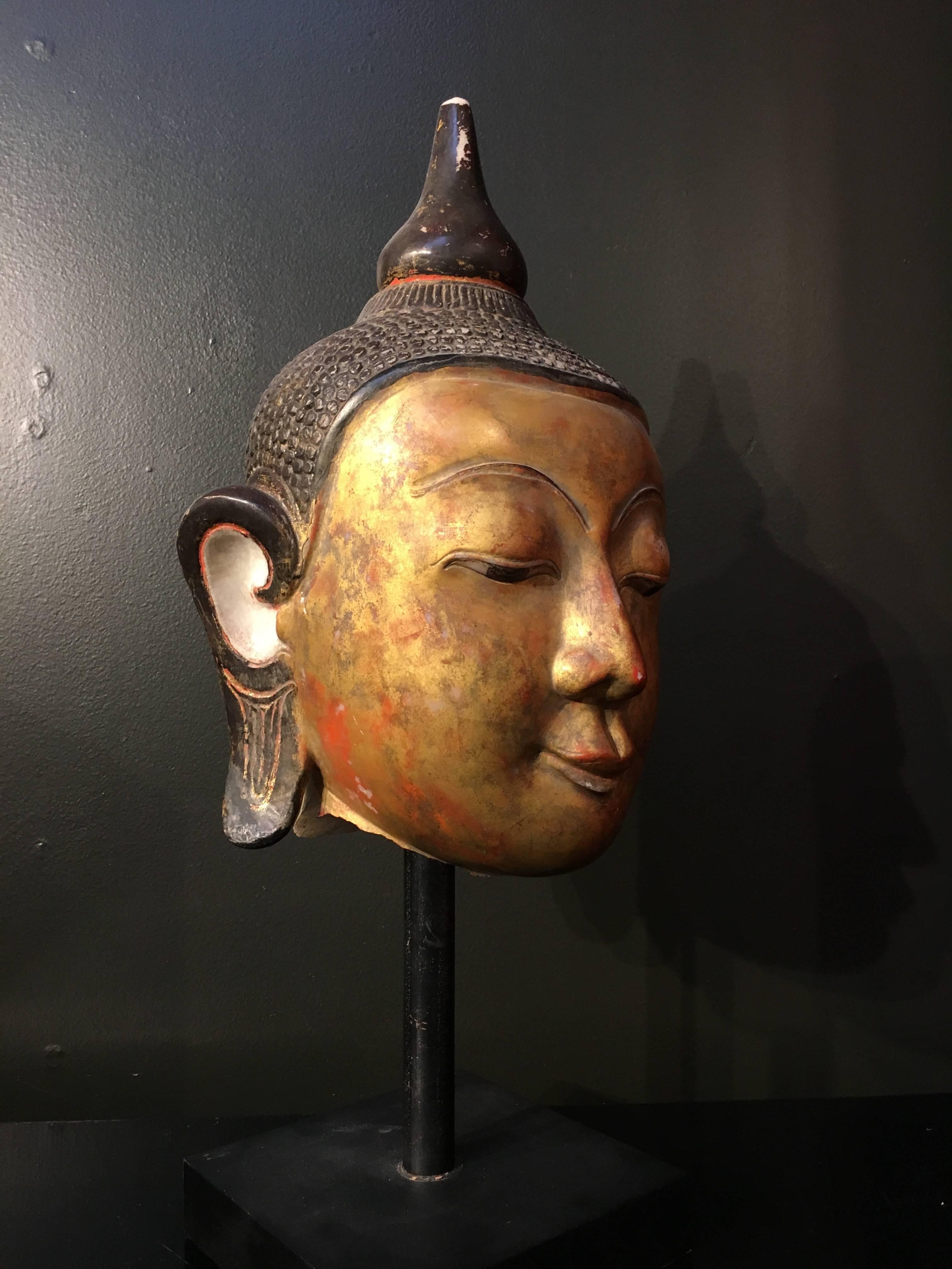 A large carved, lacquered and gilt Ava style marble head of the Buddha, Burma (now Myanmar), 17th century.

Originally part of what must have been a monumental Buddha sculpture, this carved marble head displays the finest qualities of the Ava style.