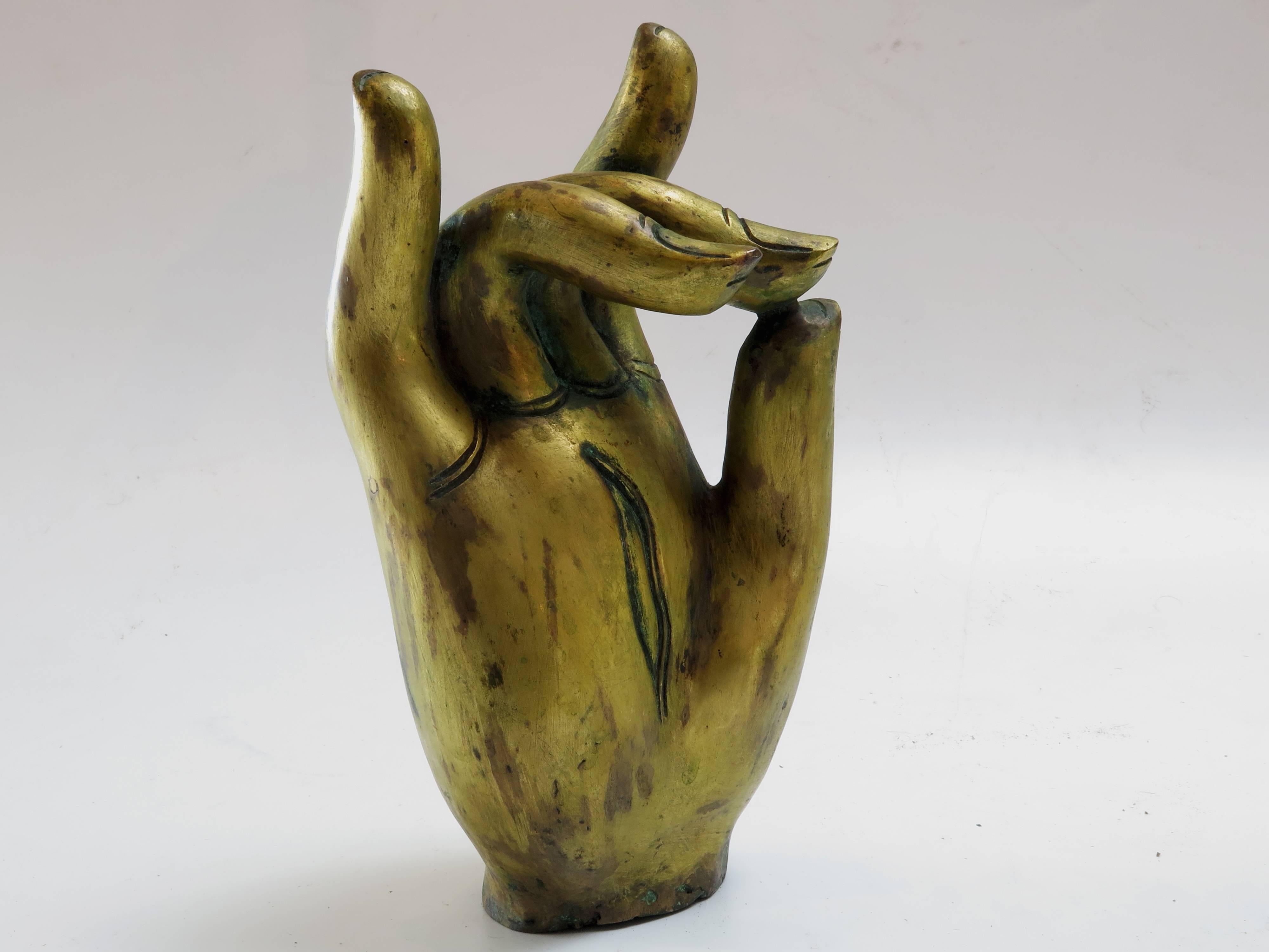 A large and well-cast, gilt right hand of a Bodhisattva. A fragment from what would have been a larger than life statue, this gracious and elegant hand has wonderful detail paid to the fingernails.
This particular hand displays the Karana mudra,