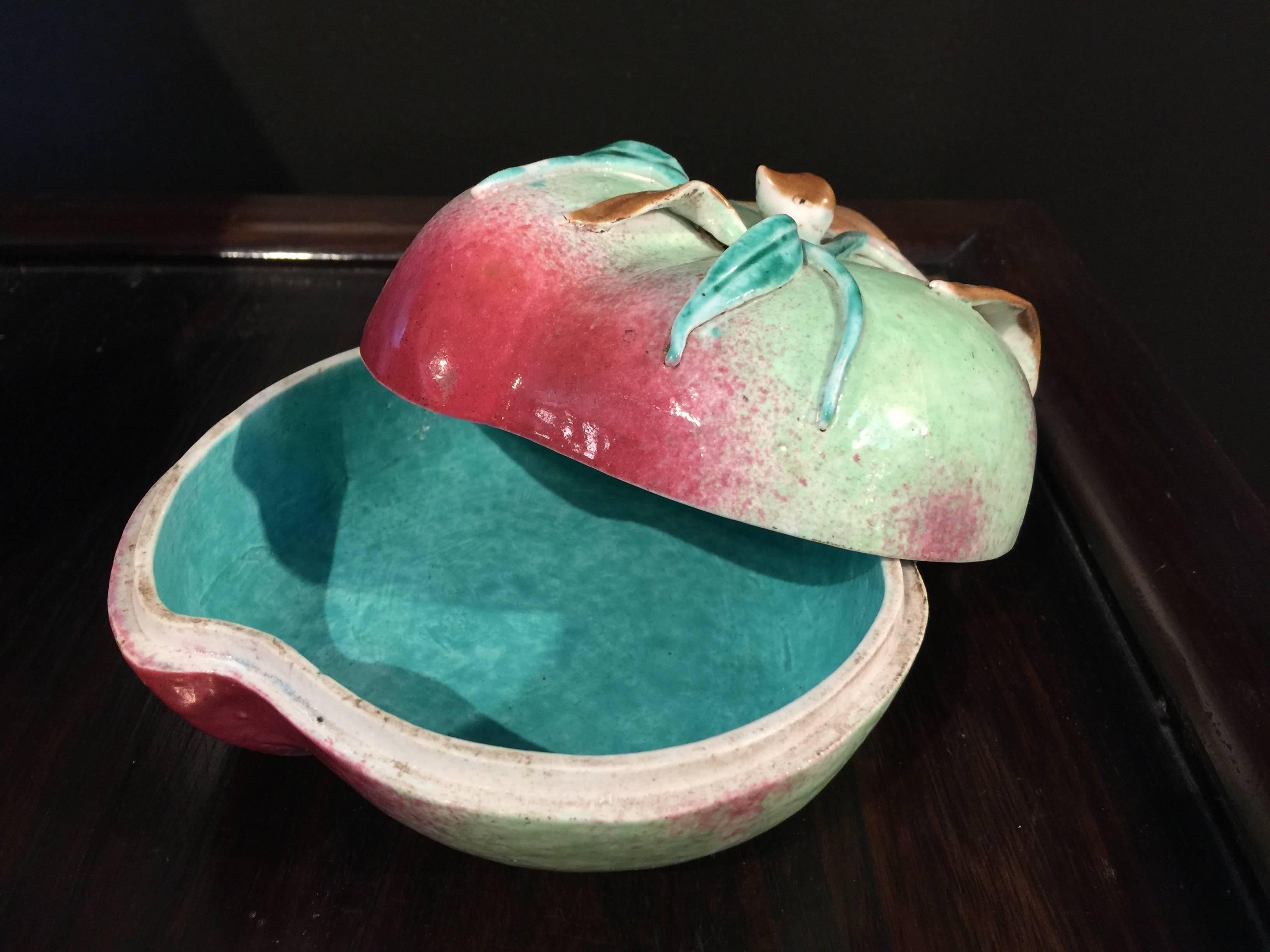 A beautiful late 19th century-early 20th century Chinese famille rose peach form box with turquoise color interior.
