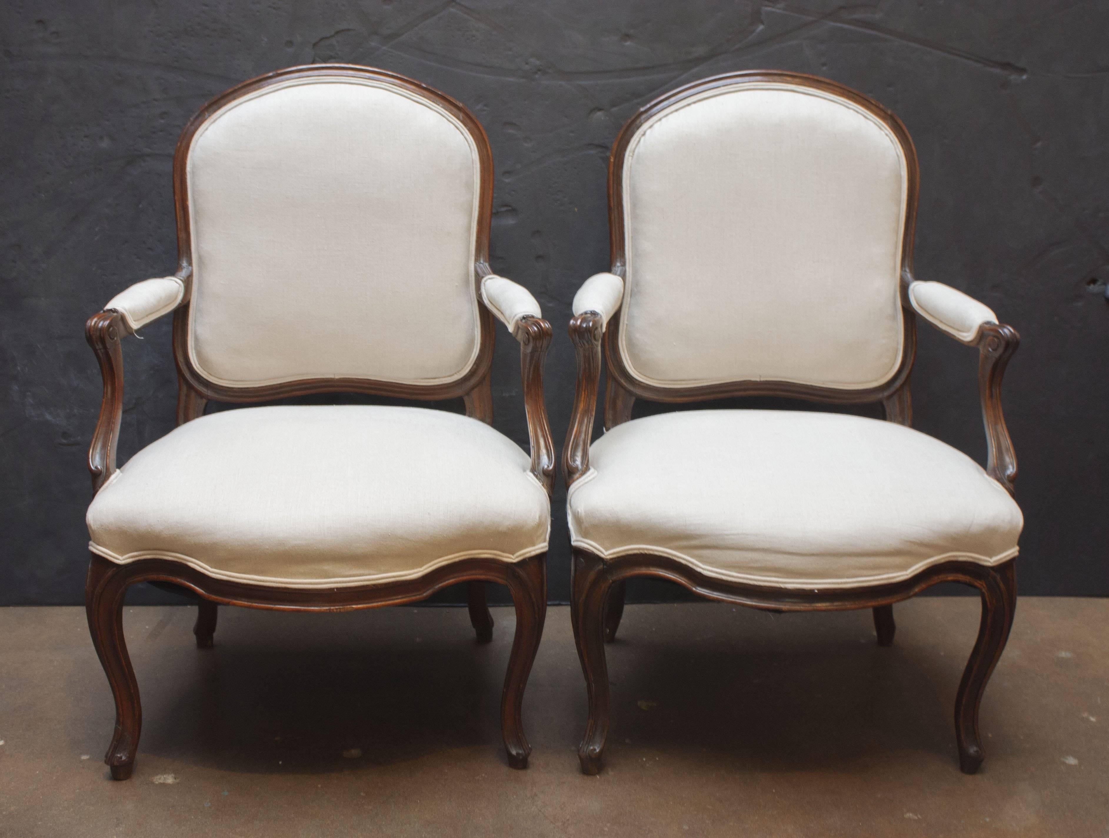 A lovely pair of Classic Louis XV fauteuils en cabriolet by Jean-Baptiste Boulard.
The walnut frame features a restrained, overall curvilinear design that speaks to the refinement of the master carpenter. 
One chair stamped 