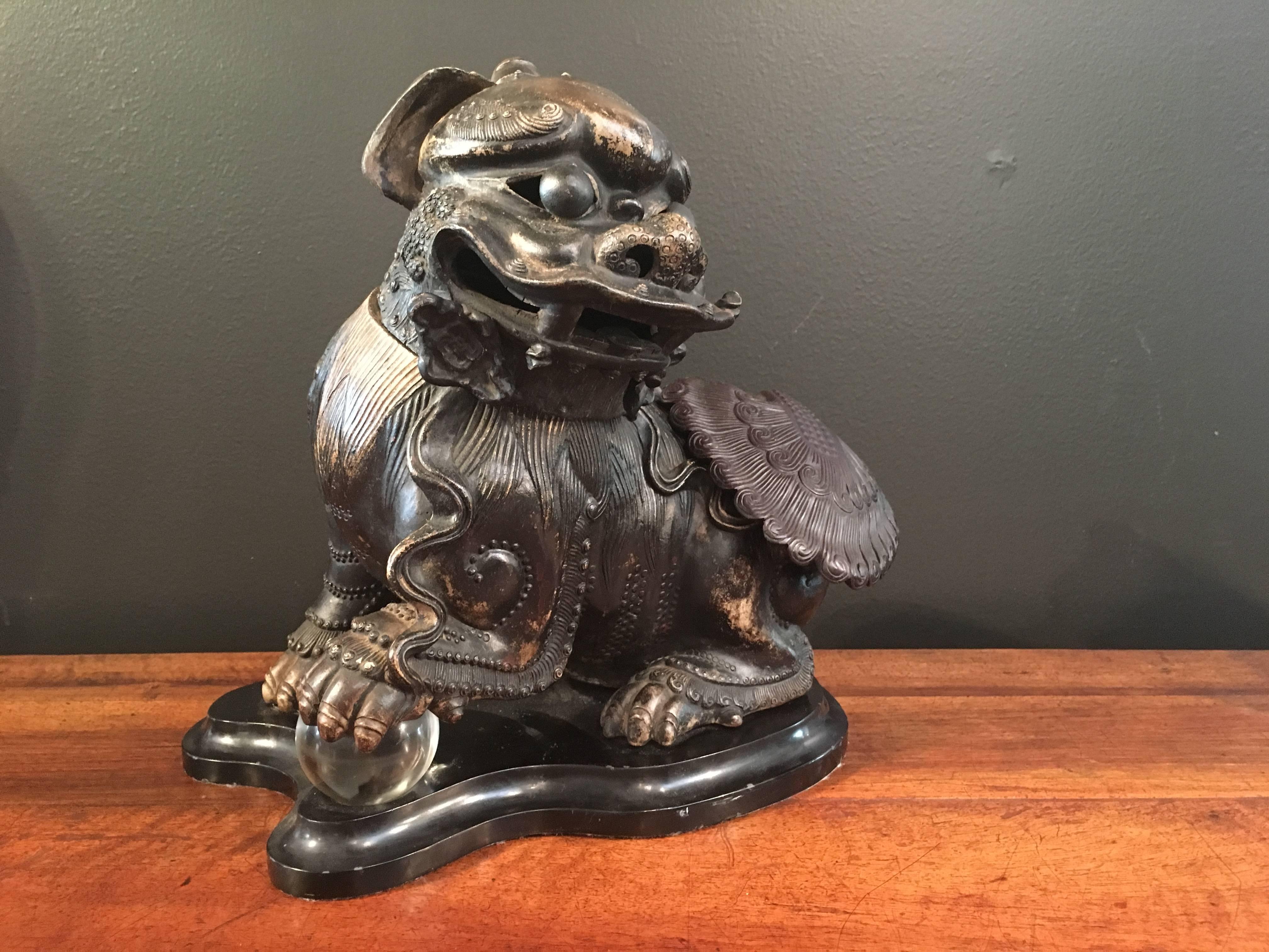 An unusual and whimsical censer modeled as a charming foo lion. The figure is well formed, with fine attention to detail. He sports a single small horn on the top of his head, framed by floppy ears. His bulging eyes, separately molded, and loose in
