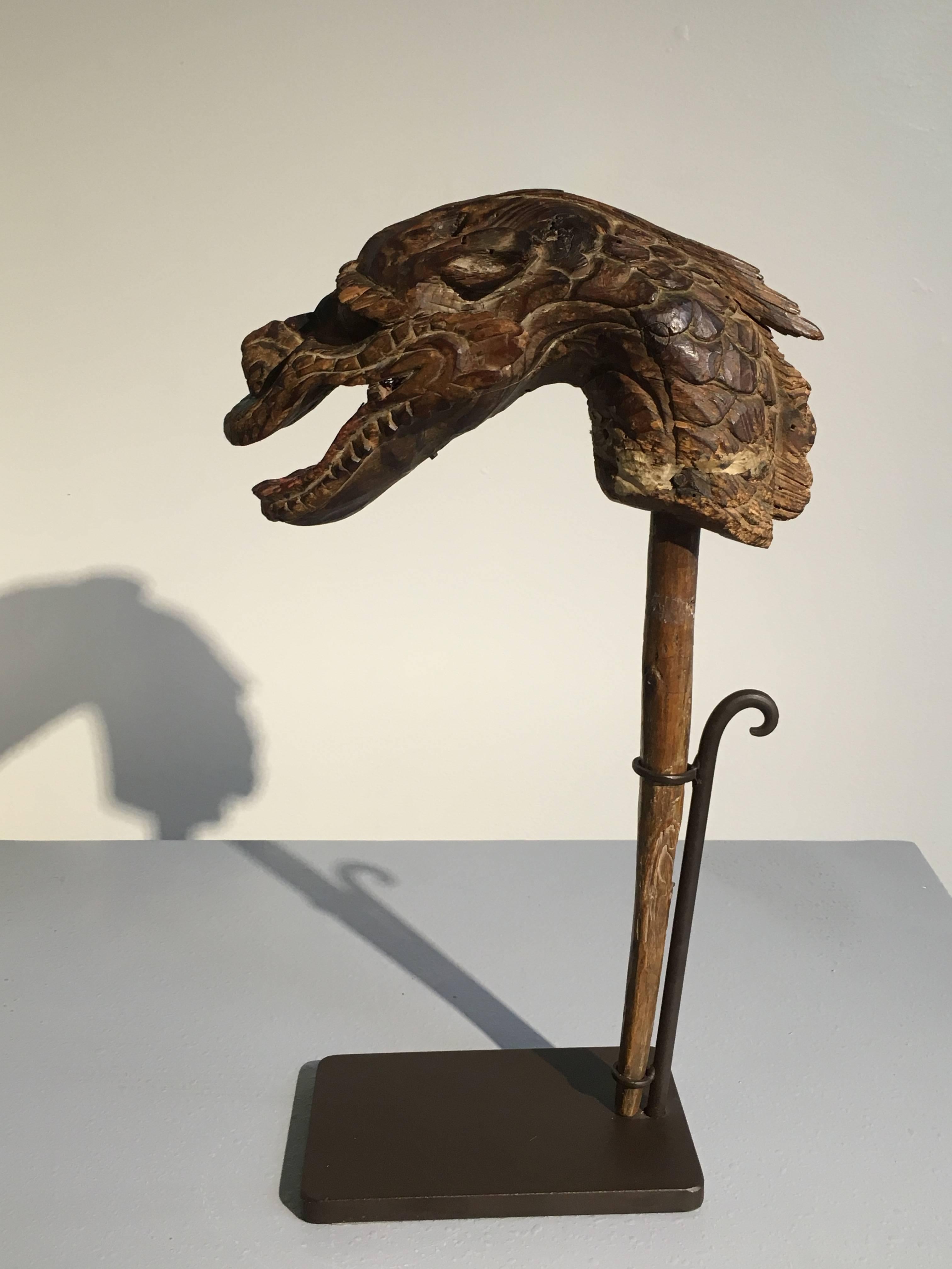 A fabulous Japanese mingei (Folk Art) carved pupped head in the form of a dragon. Edo period (1603-1868), early 19th century or earlier.
Carved from keyaki (elm) wood, as if moving and undulating. The sinuous dragon has large, bulling eyes which