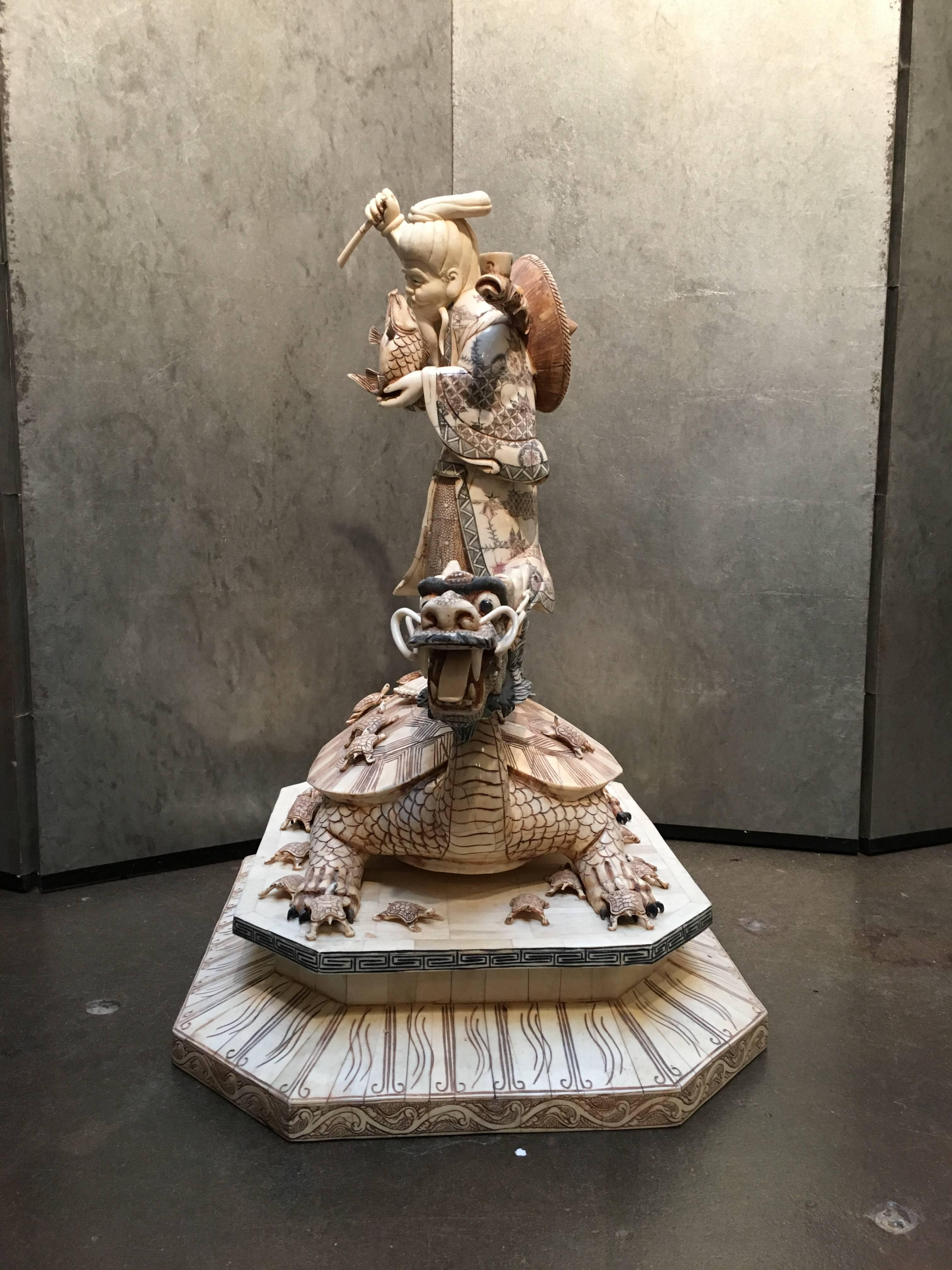 A large and fantastic vintage Japanese bone veneered sculpture of Ebisu, the Japanese God of the Sea,  riding a mythical turtle dragon, circa 1980's, Japan.

Ebisu, patron god of fisherman, the god of luck, and one of the Seven Lucky Gods, is