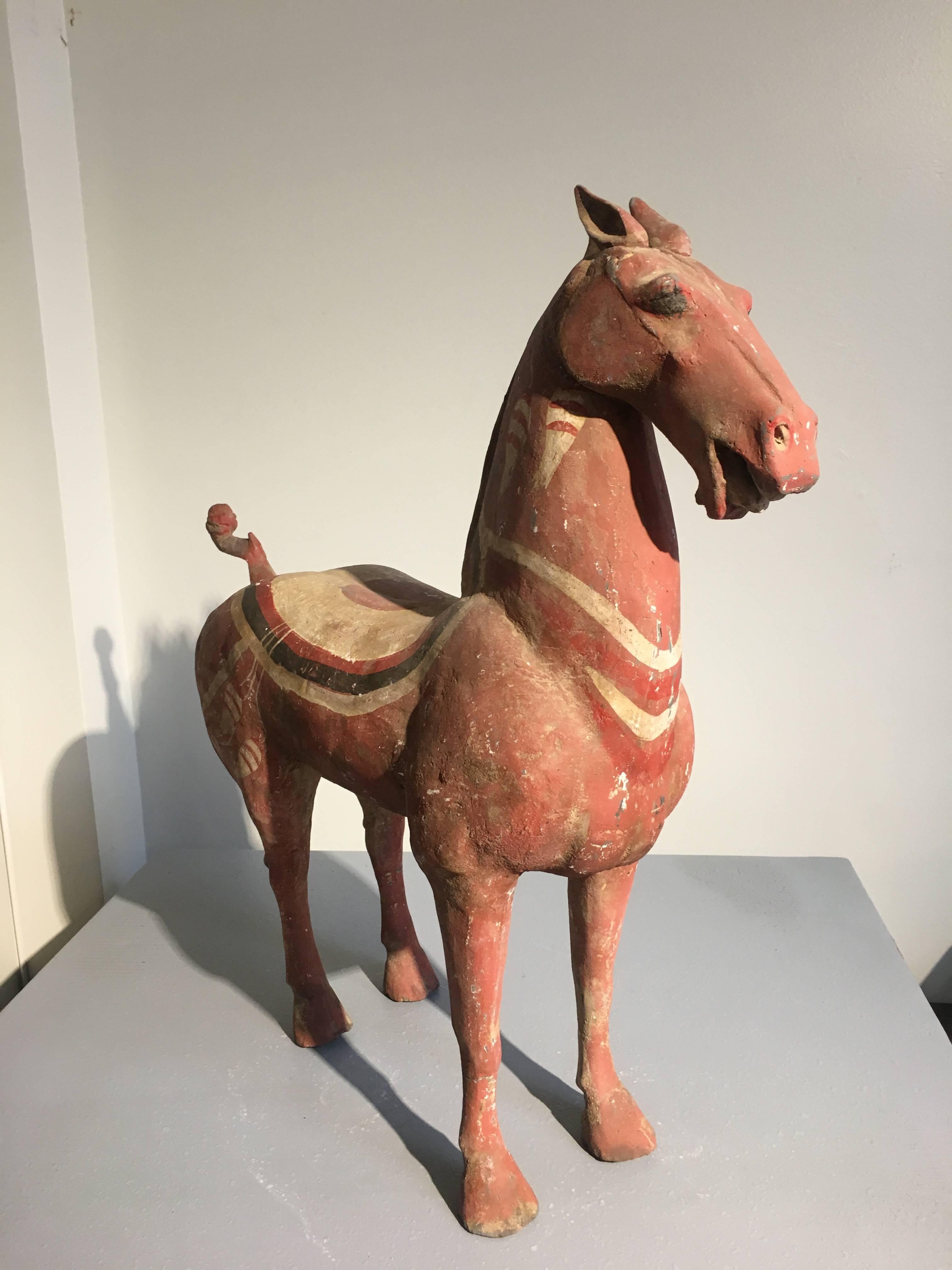 A good Han dynasty high fired gray pottery painted figure of a horse. 
Portrayed standing foursquare on slender legs, with nice musculature throughout, including well rounded haunches and an elegantly shaped neck, with a noble countenance. The
