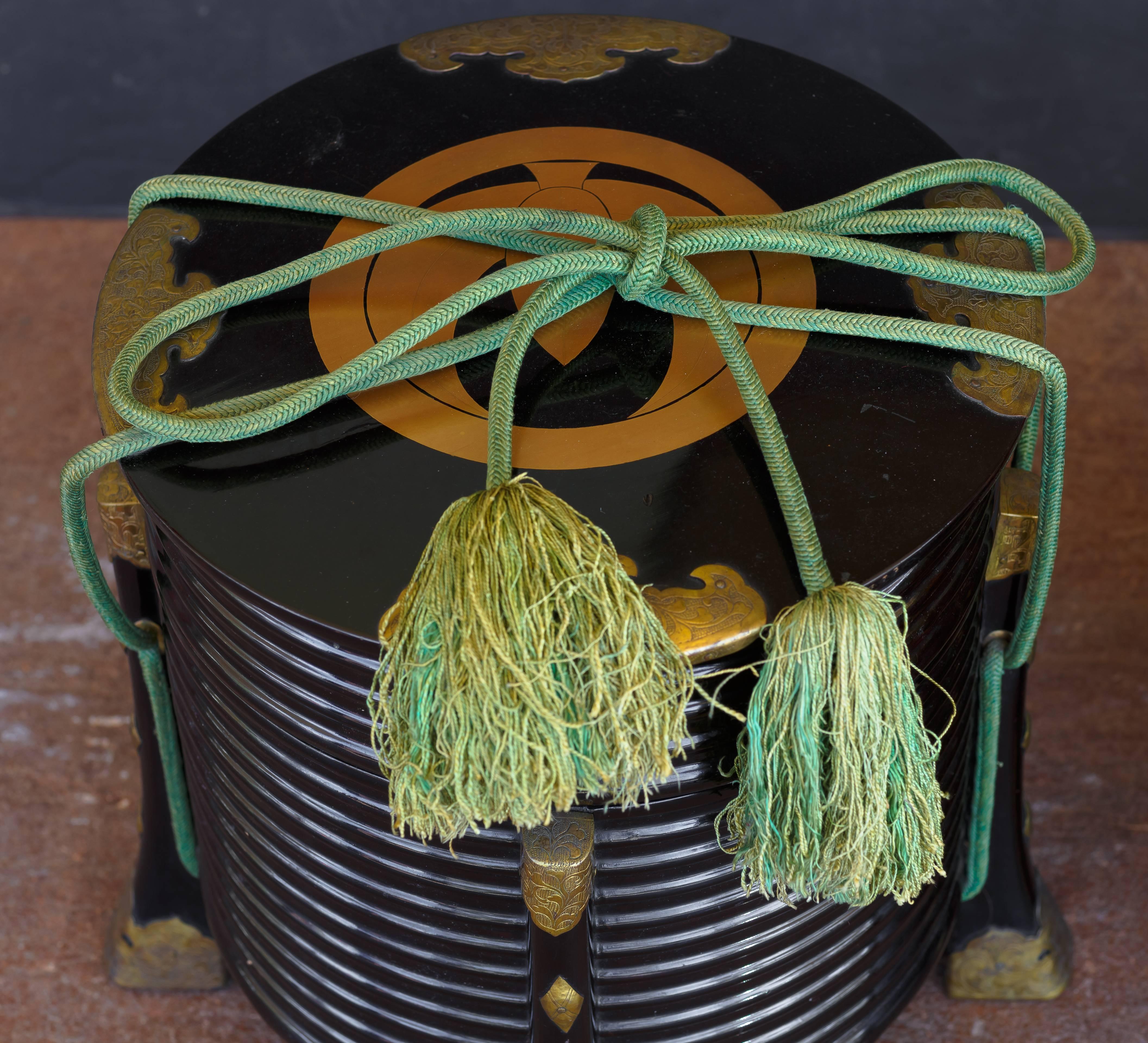 An elegant pair of Japanese late Meiji period hokkai, or picnic boxes. Crafted of black lacquer, and decorated in maki-e, with gilt copper mounts.
The body shaped as a series of stacked rings. Four legs run up the sides of the body, and are