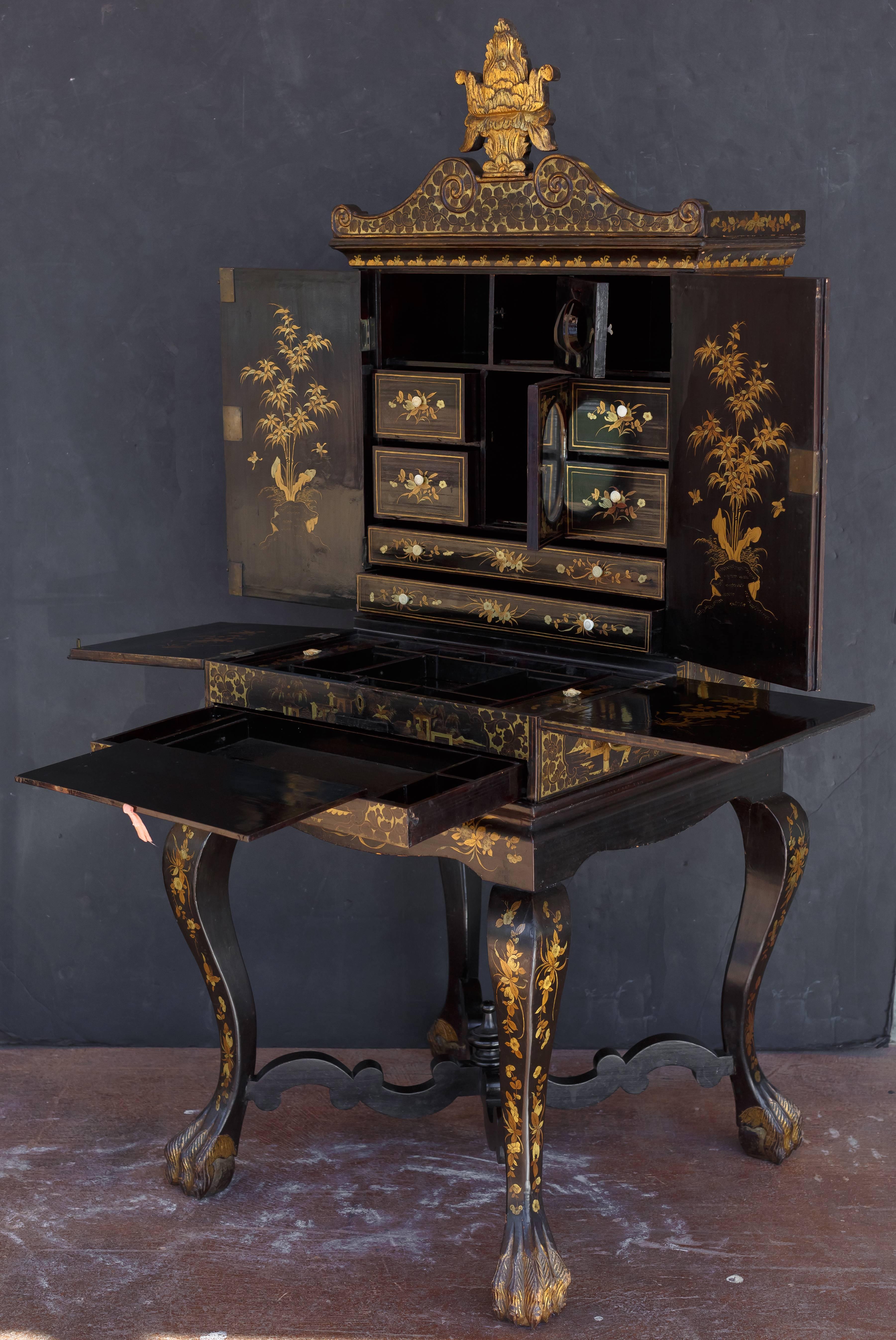 An exquisite late Victorian chinoiserie ebonized and gilt painted lady's vanity.
Comprised of three sections: the cabinet, sewing box and stand.
The cabinet and sewing box both rest on the square stand and are removable. The cabinet topped by a