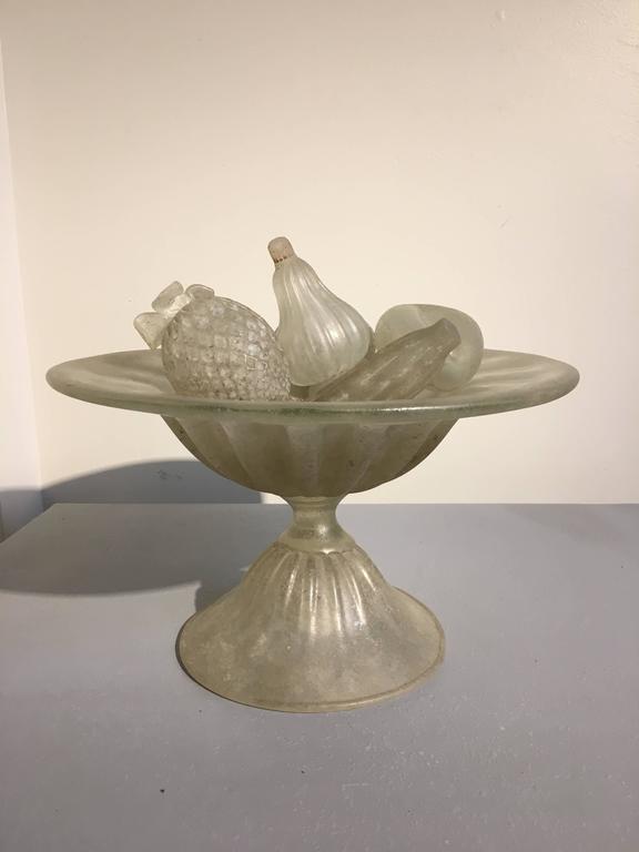 An elegant and unusual group of assorted Murano glass fruit and matching bowl.
Comprised of seven pieces of fruit and a compote shaped bowl. The glass with nice iridescence and near frosted finish.
Each piece bearing a 