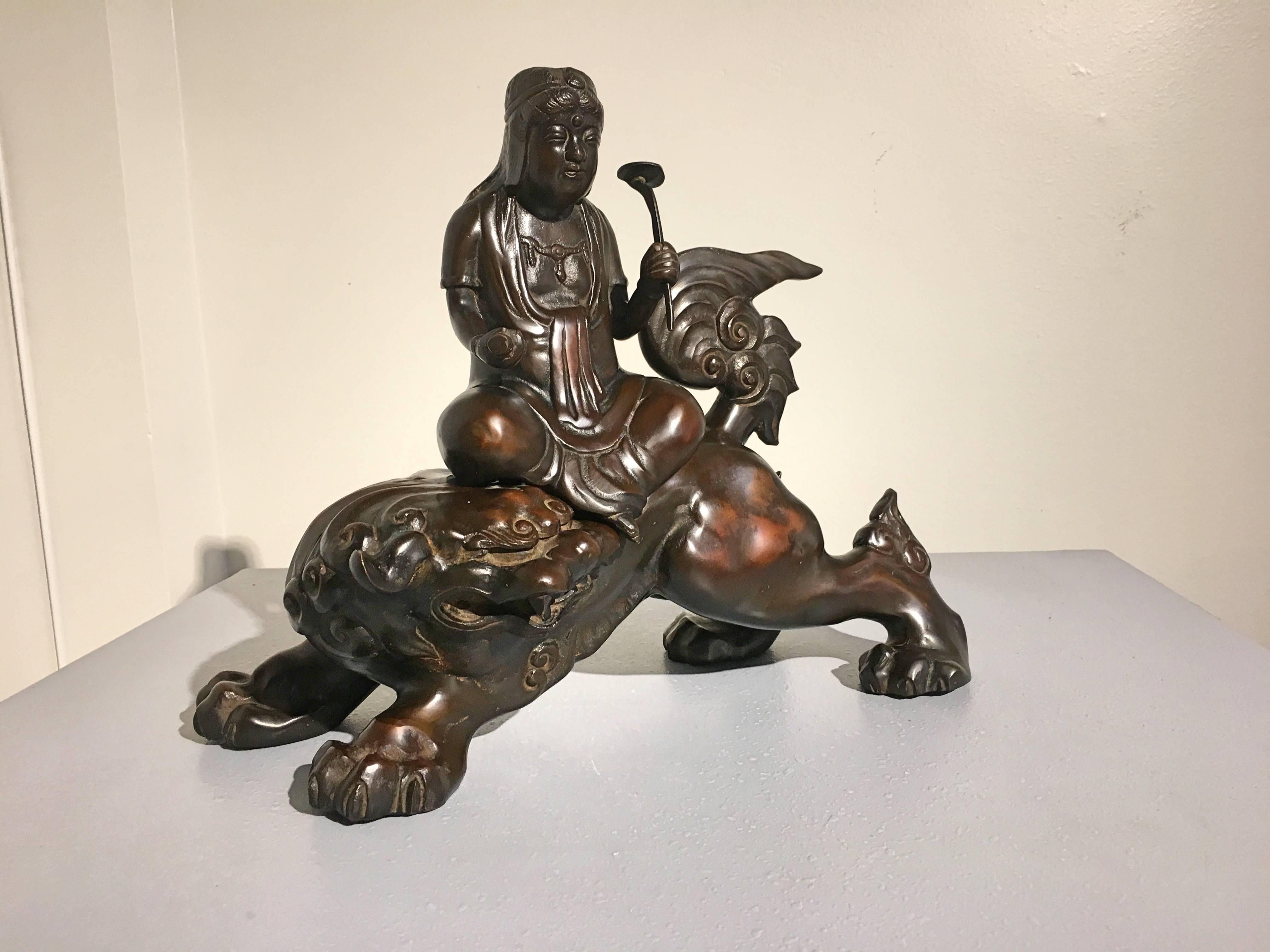 A powerfully sculpted Japanese Taisho Period cast bronze figure of the Buddhist deity Manjushri, known as Monju Bosatsu in Japan, riding atop a ferocious lion.
This Art Deco period sculpture portrays the bodhisattva of Wisdom and Law seated upon a