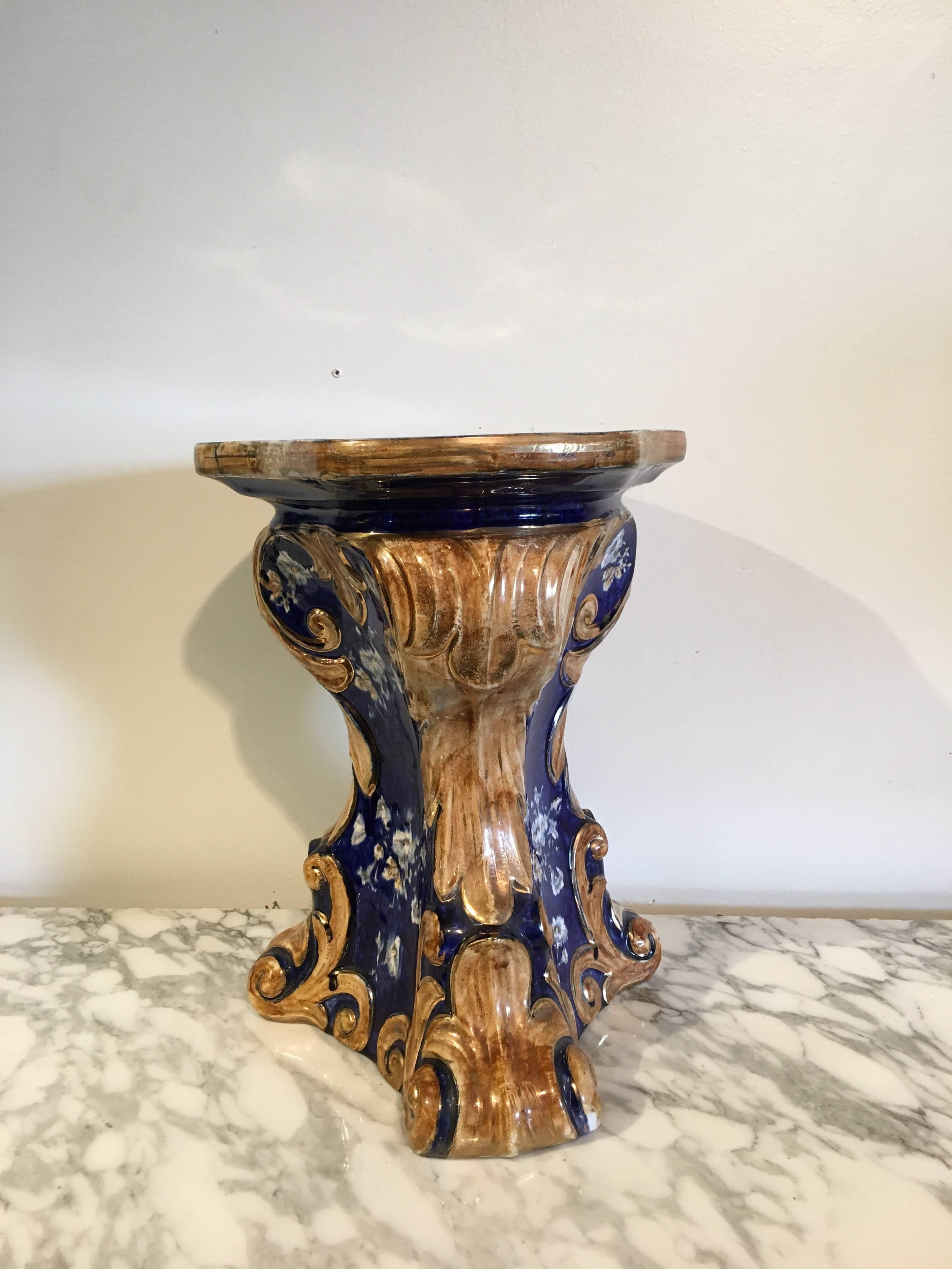 A gorgeous Majolica garden seat or plant stand, late 19th century, Italy. Decorated in a deep cobalt blue, with clusters of white hibiscus. Scrolling acanthus leaves in a pleasing dark straw color and highlighted in gilt forming the 