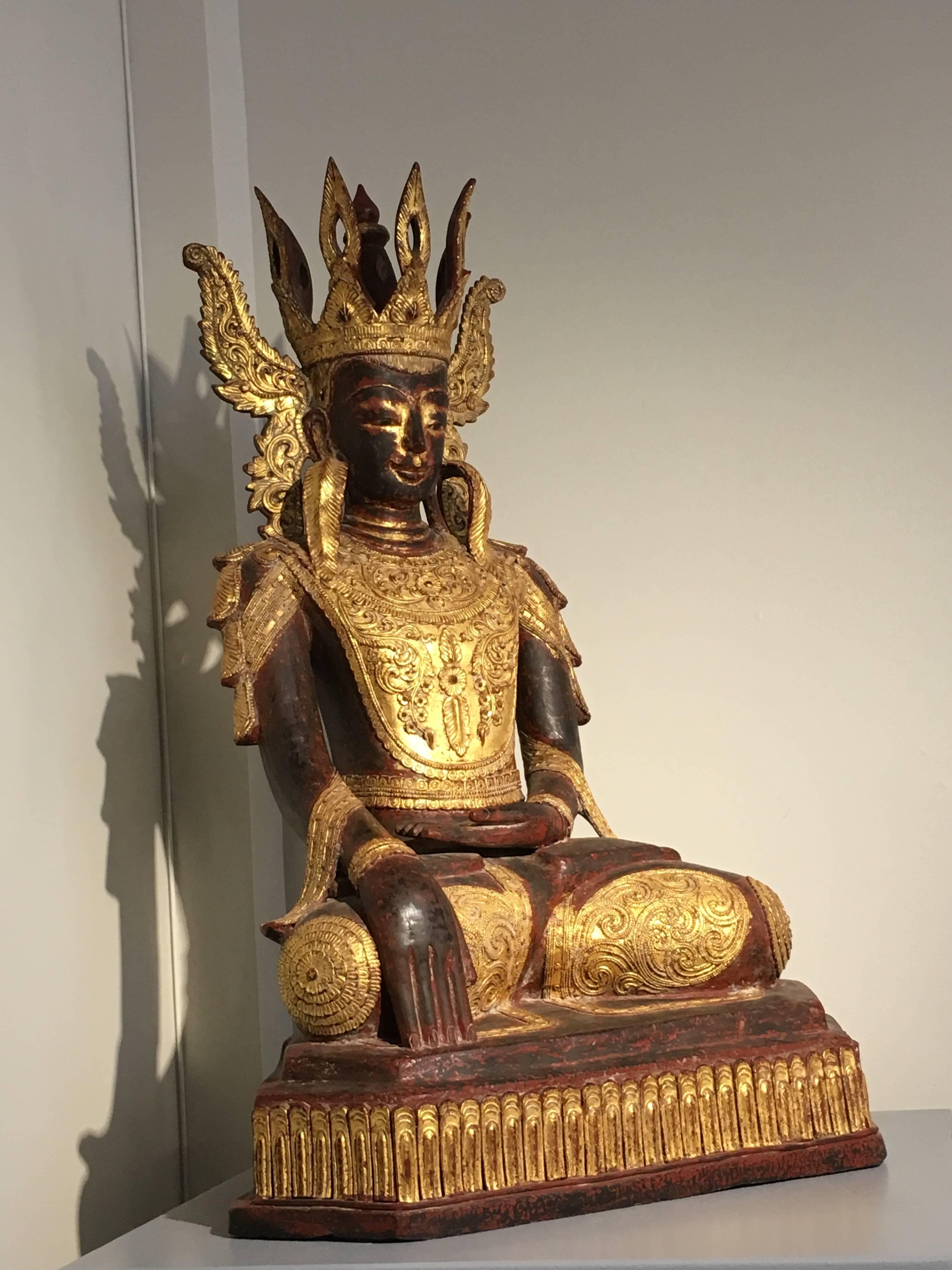 A truly stunning Shan Burmese dry lacquer crowned Buddha in royal attire, known as Jambupati Buddha, early 20th century, Burma.
The near life sized Jambupati Buddha is portrayed seated upon a stylized lotus pedestal, hands in bhumisparsha mudra (the