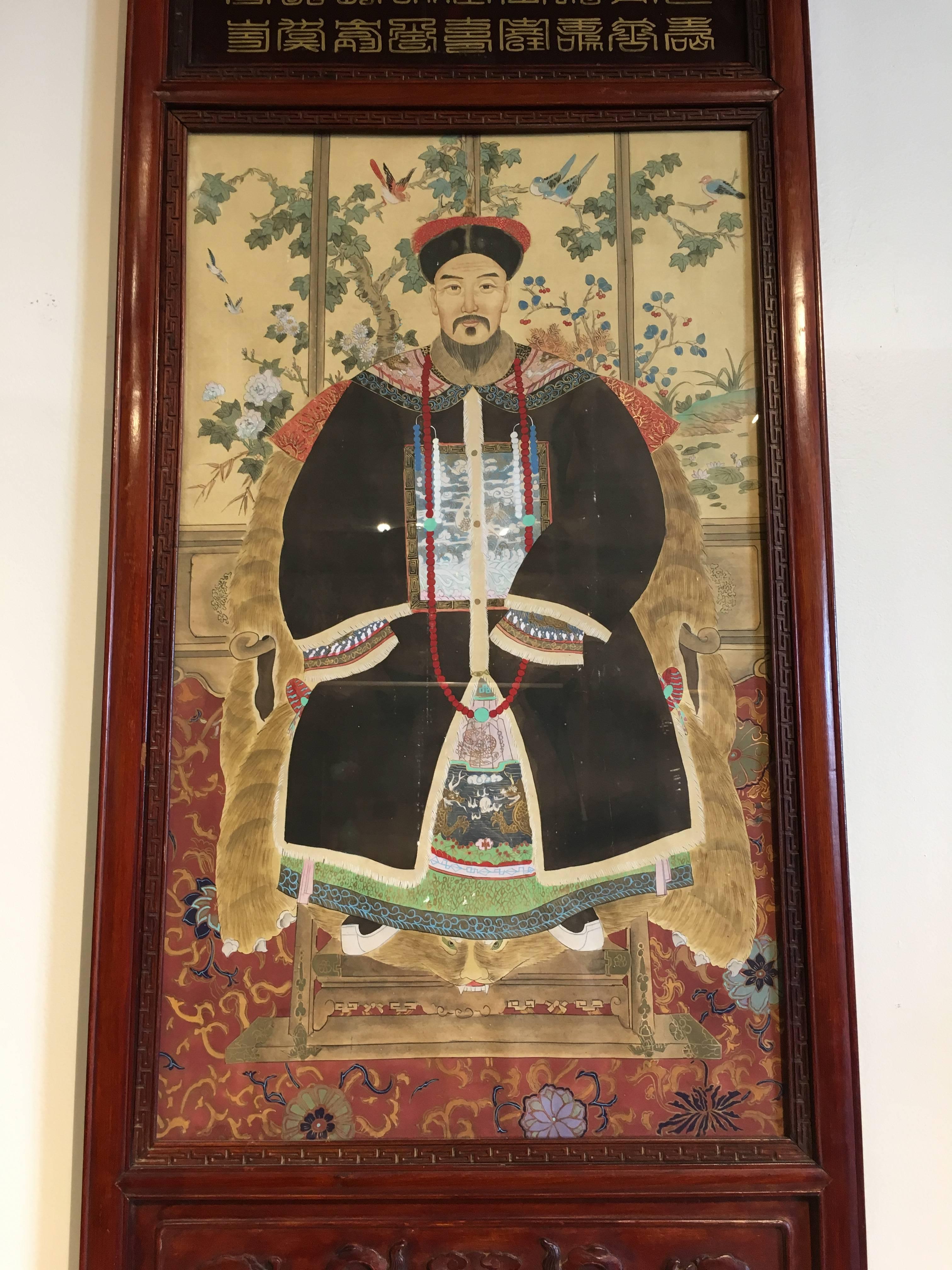A pair of hand-painted ancestor portraits in hand-carved rosewood frames, with reverse glass painted accents.
Painted during China's Republic Period (1912 to 1949), the portraits are portrayals of members of the Qing Dynasty imperial court. The