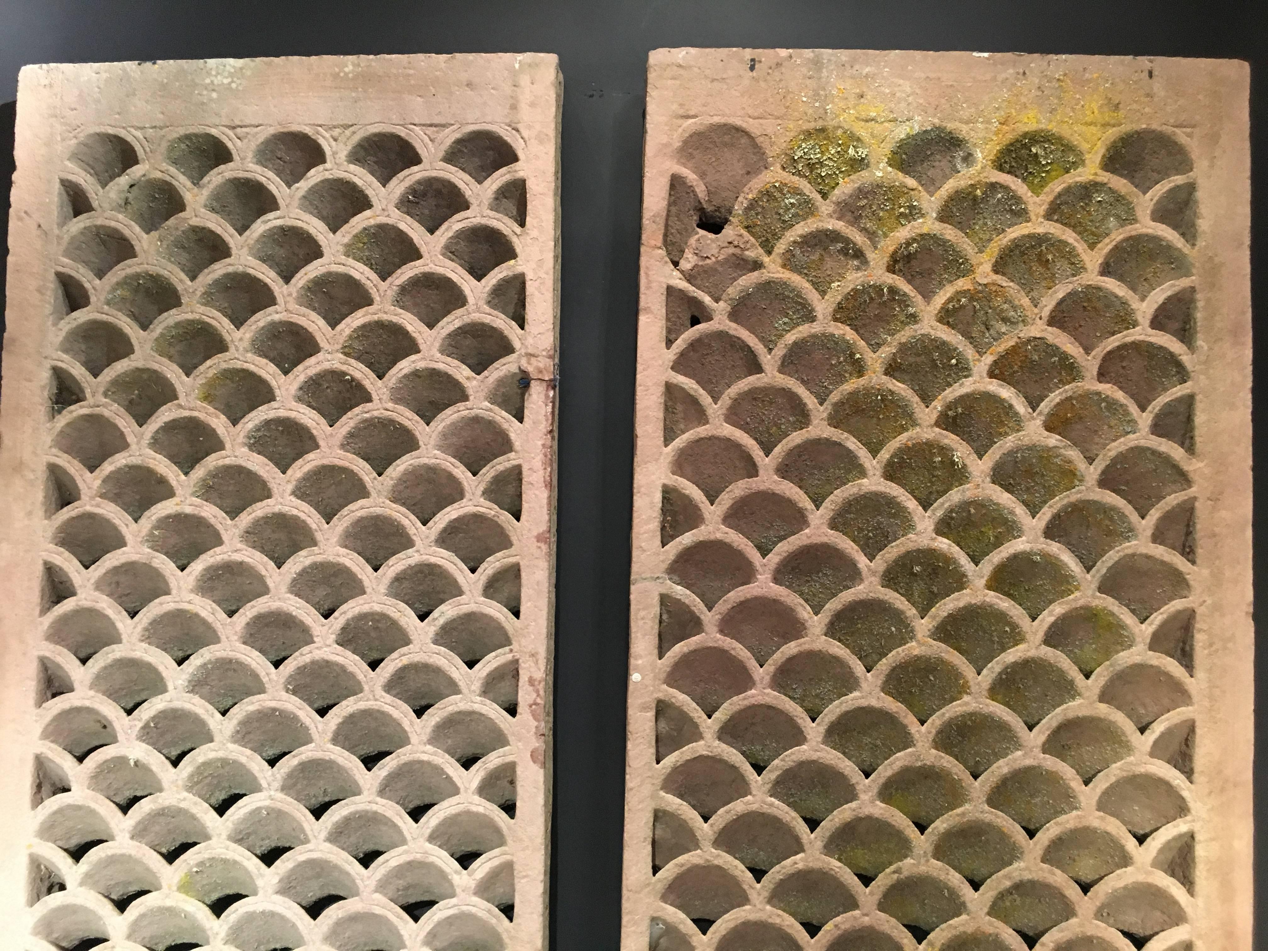 A stunning pair of Indian sandstone jali panels, carved, undercut, and pierced in a fish scale pattern.
Each panel carved from a single slab of sandstone. The scales carved in an overlapping pattern, each scale with an incised line following the
