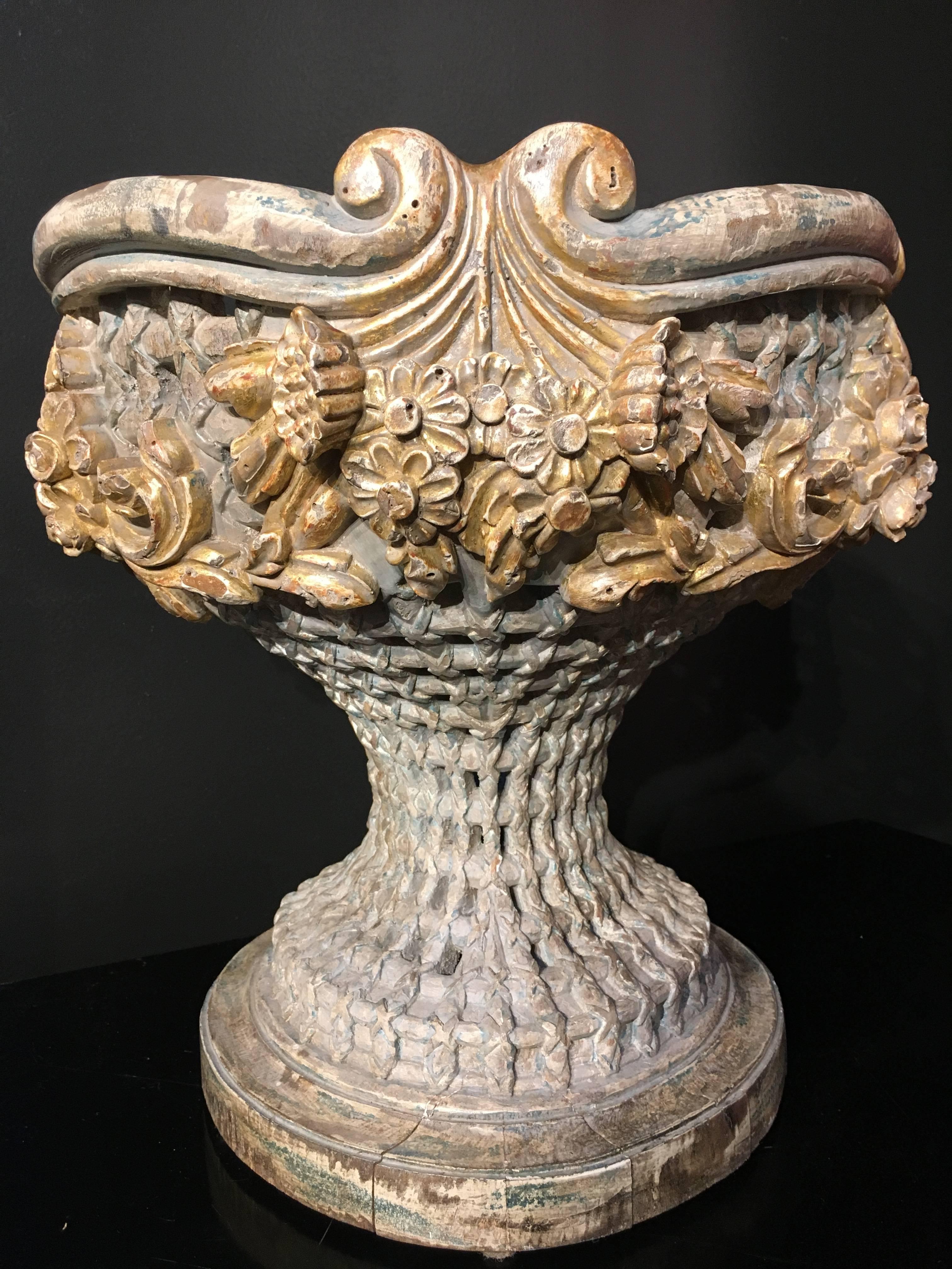 A finely carved Italian Empire Revival, polychromed and giltwood jardiniere or centerpiece, dating to circa 1900. The wooden vessel of gracious and elegant form, meticulously carved and reticulated to mimic a woven basket, with lush garlands of