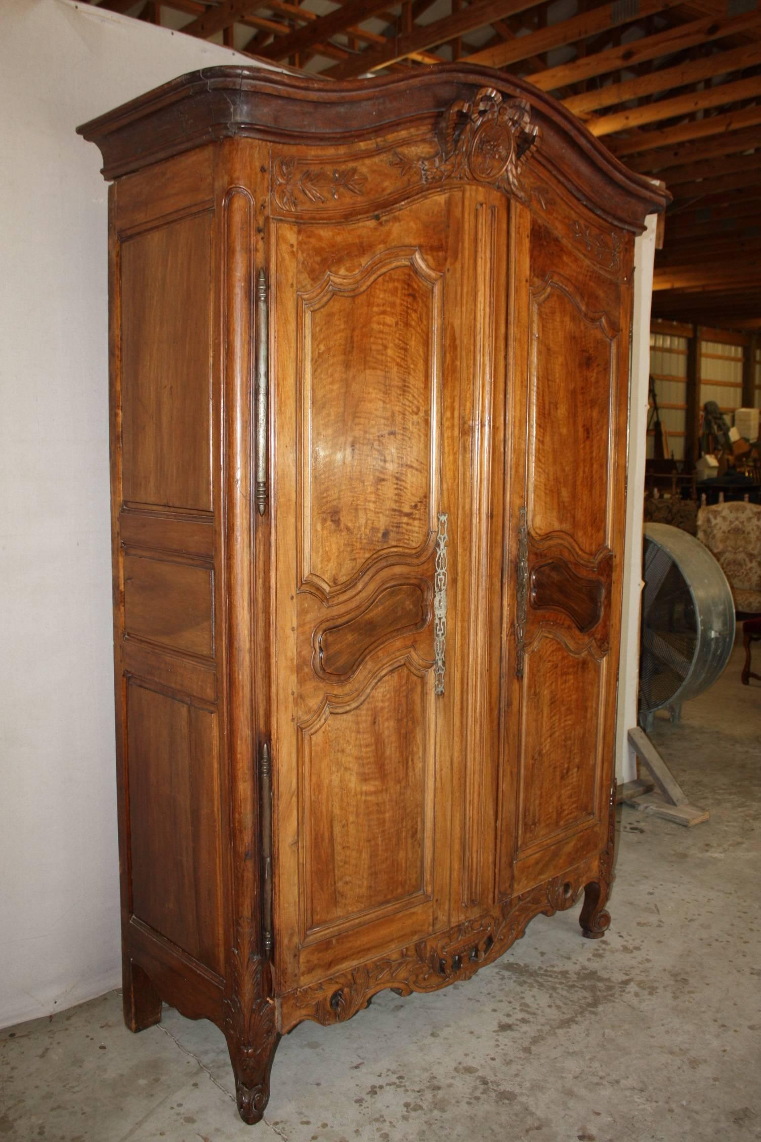 19th century French walnut armoire with it's original hardware and finely carved panels. Would make a great storage peace for any bedroom, dining room or study.