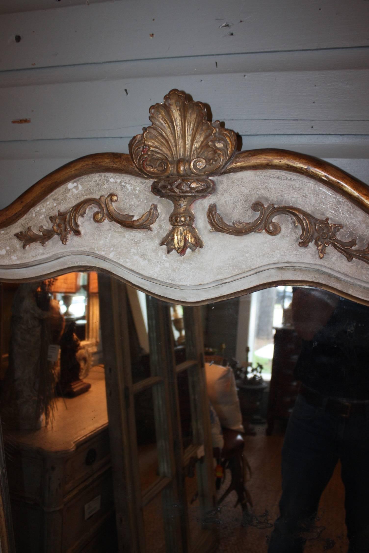19th century painted Louis XV Mirror with gilt carved wood shell cartouche. Original split mercury backed mirror, as large single piece of glass were rare at the time. This mirror would complement all styles. It is 27