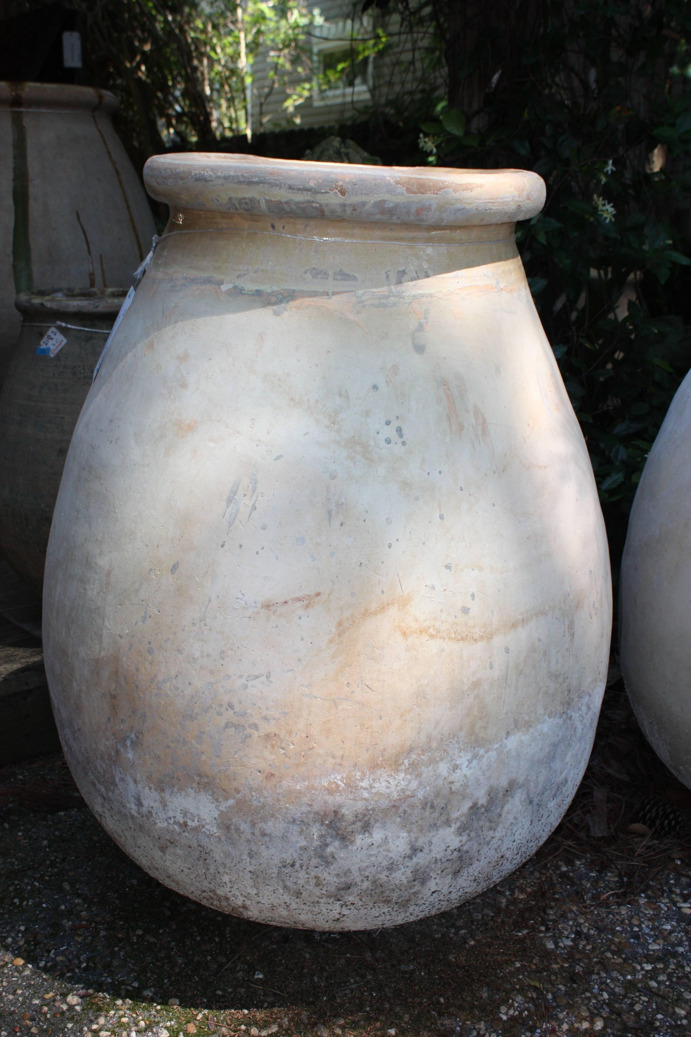 Very large French terracotta Biot olive jar with an attractive shape, patina and yellow glazing.