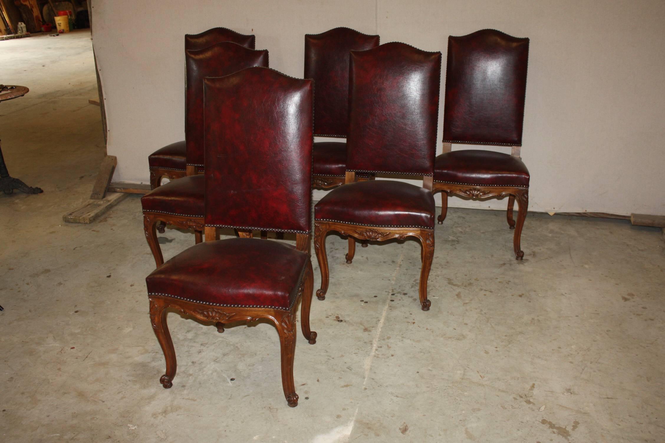 Set of six Louis XV style dining chairs having acanthus carved sides, central skirt and cabriole leg. These chairs also feature fully upholstered back with nailhead trim.