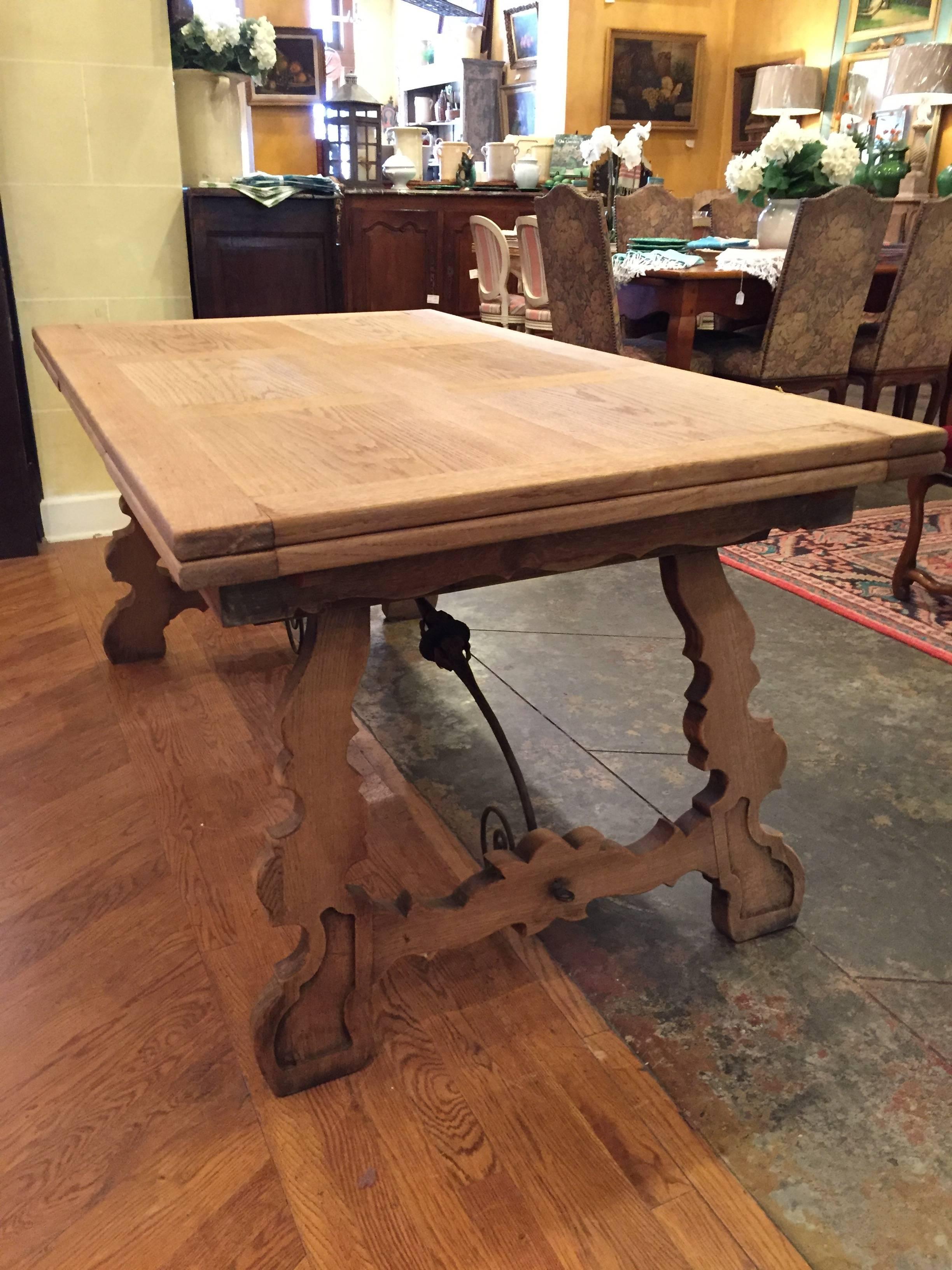 Magnificent 19th century Spanish draw-leaf farm table constructed from bleached or washed oak and hand-forged iron stretchers. Would work great as a dining table, but could also make a great console or writing table as well.

Length 63