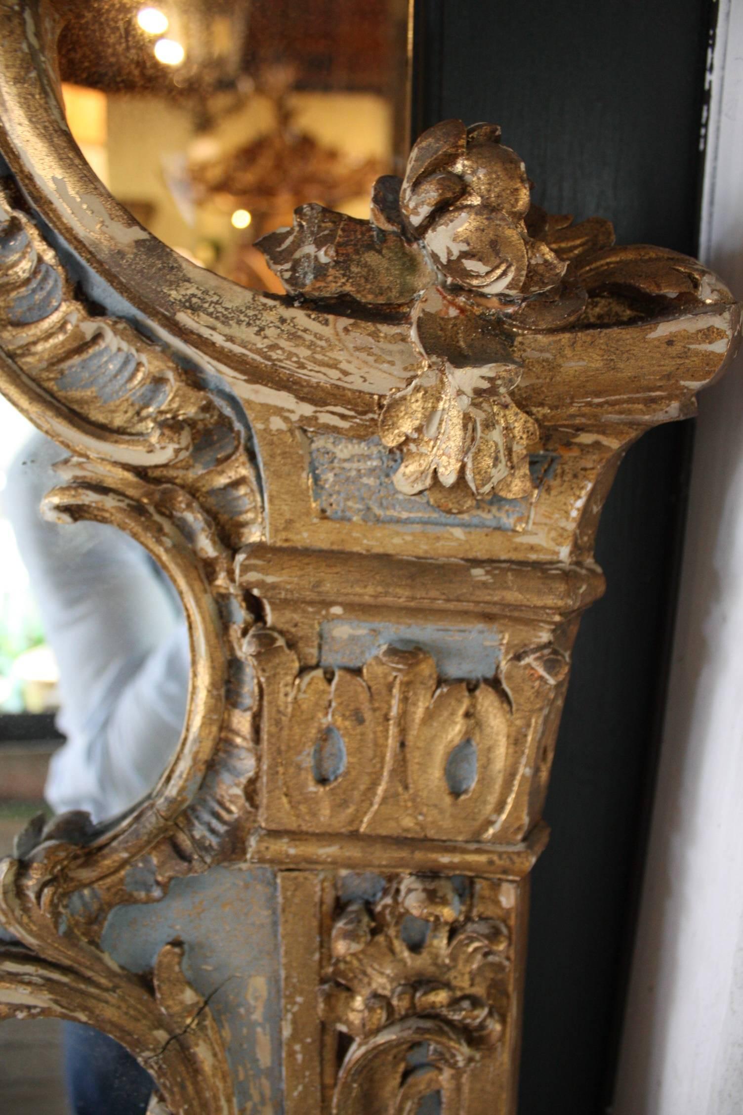 Louis XV style painted and gilt mirror with upper and lower mirror plates framed by gilt decorative molding, 19th century.