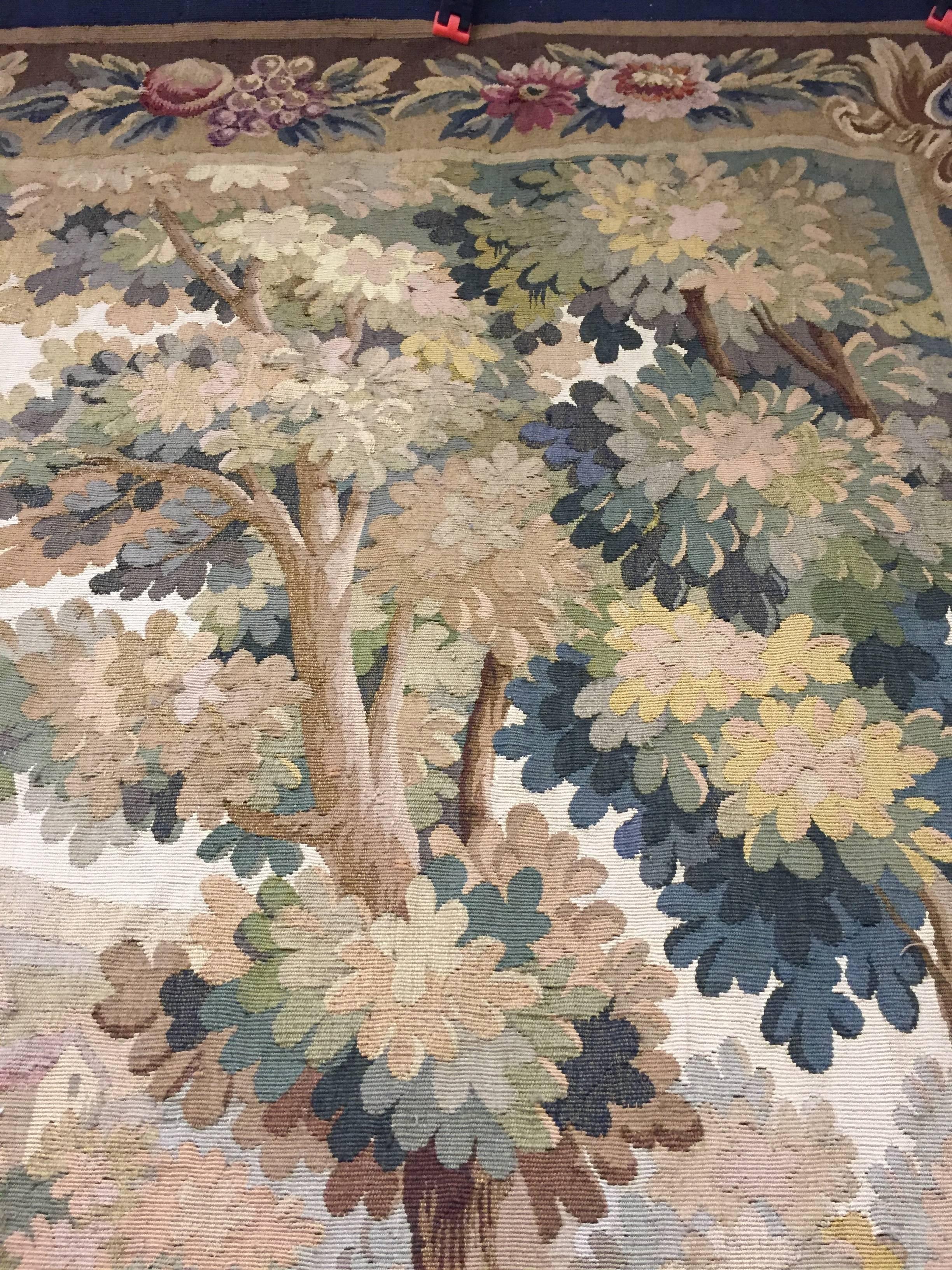 Very beautiful antique Aubusson tapestry with a stag and hounds in the woods near backed in taupe cotton with soft blues and taupe colors. The details are magnificent. This would soften any wall and could compliment so many different interior