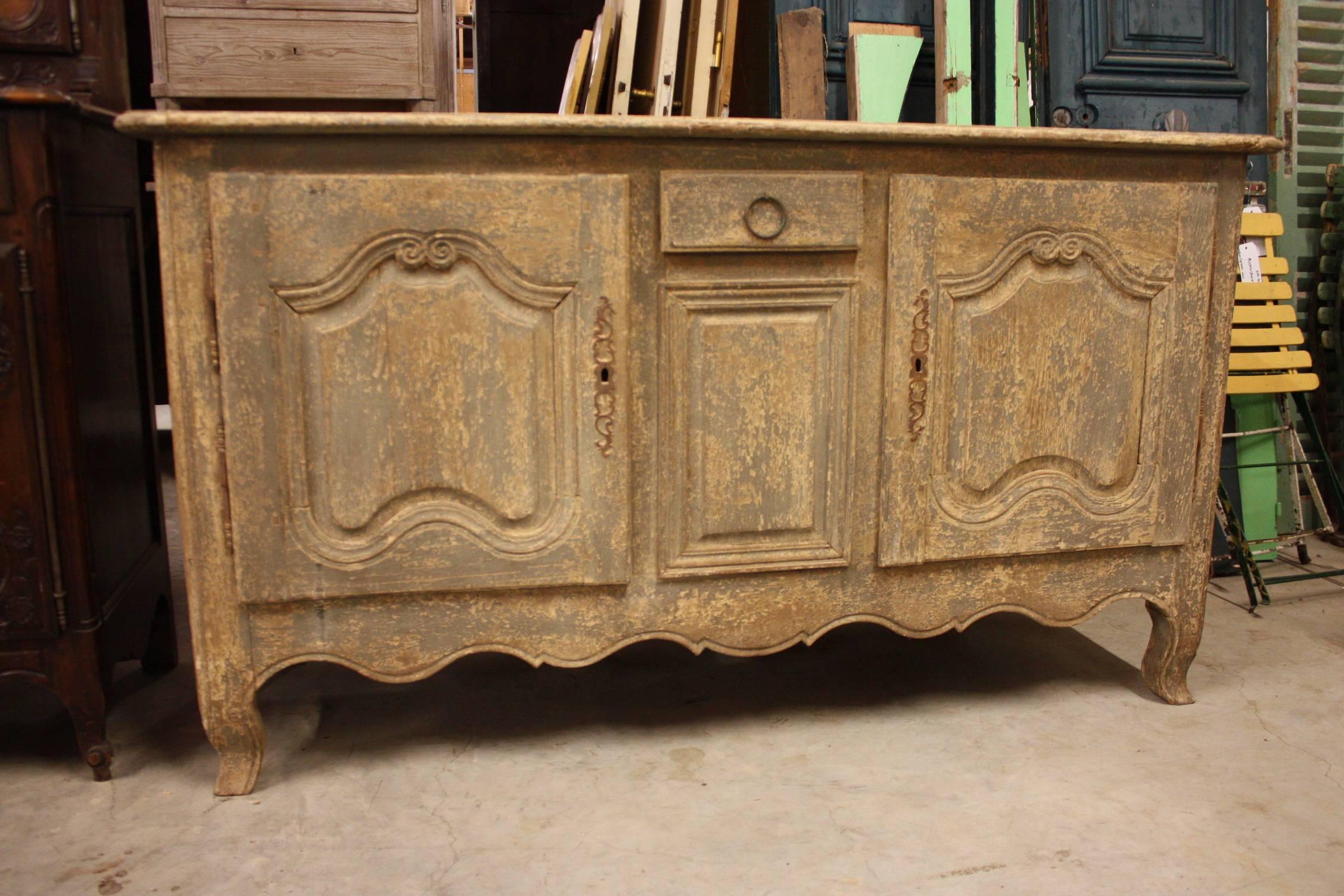 Beautifully carved Louis XV style enfilade with one drawer and two doors. Original locks with keys. Painted in a soft blue washed patina and has wonderful dimensions, 19th century.