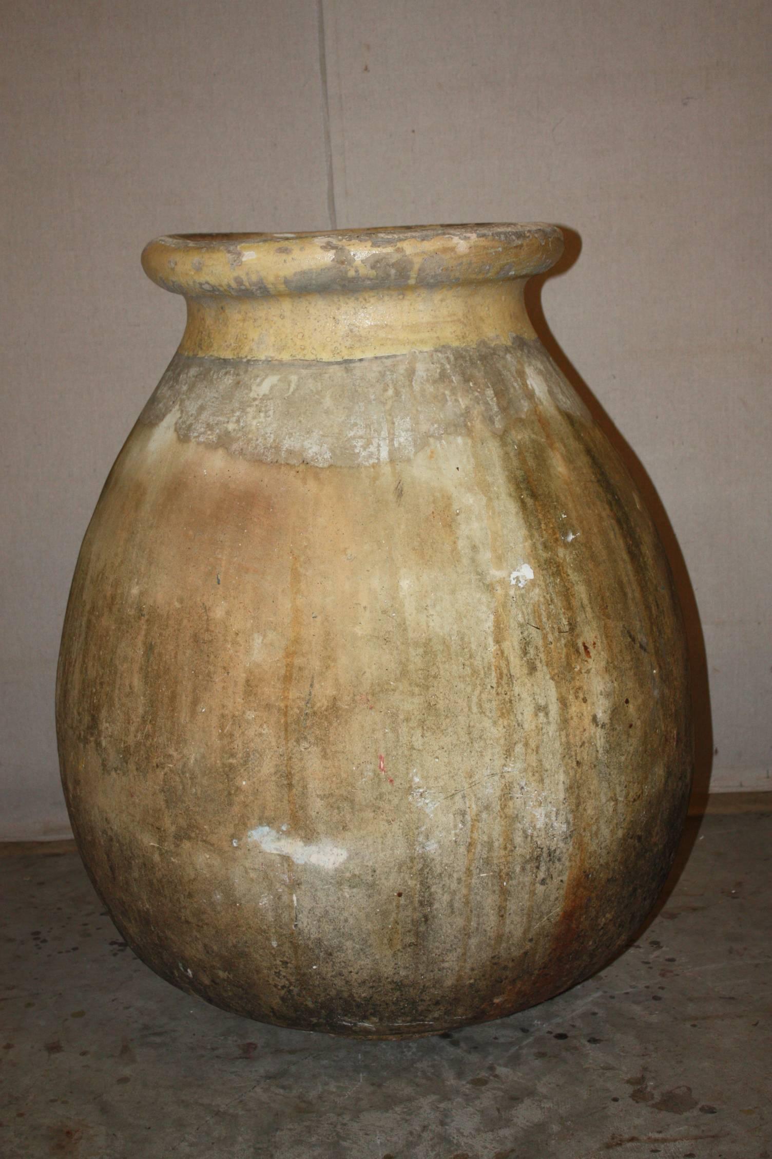 This is a very nice large French olive jar made in Biot, Provence in the early 1800s. It has a nice bulbous shape. The glaze has a rich yellow tone. It is in great shape for its age.
