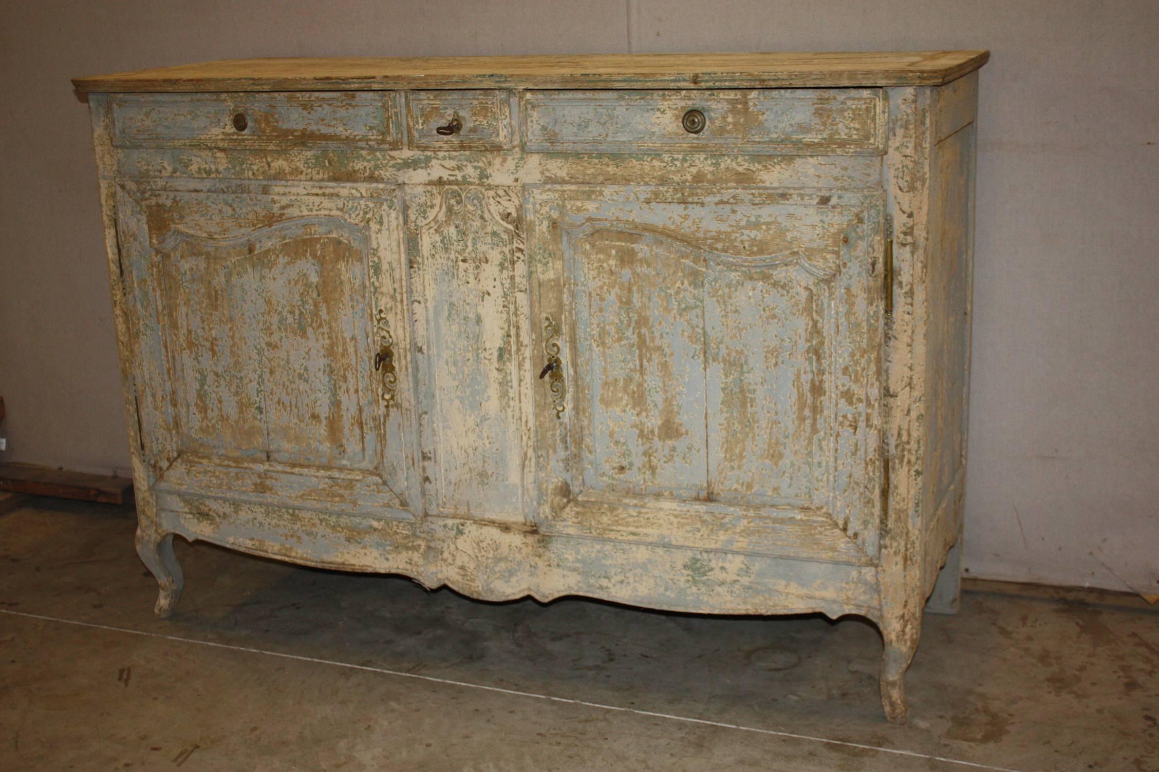 Beautifully carved Louis XV style enfilade with one drawer and two doors. Original locks with keys. Painted in a soft blue washed patina and has wonderful dimensions, 19th century.