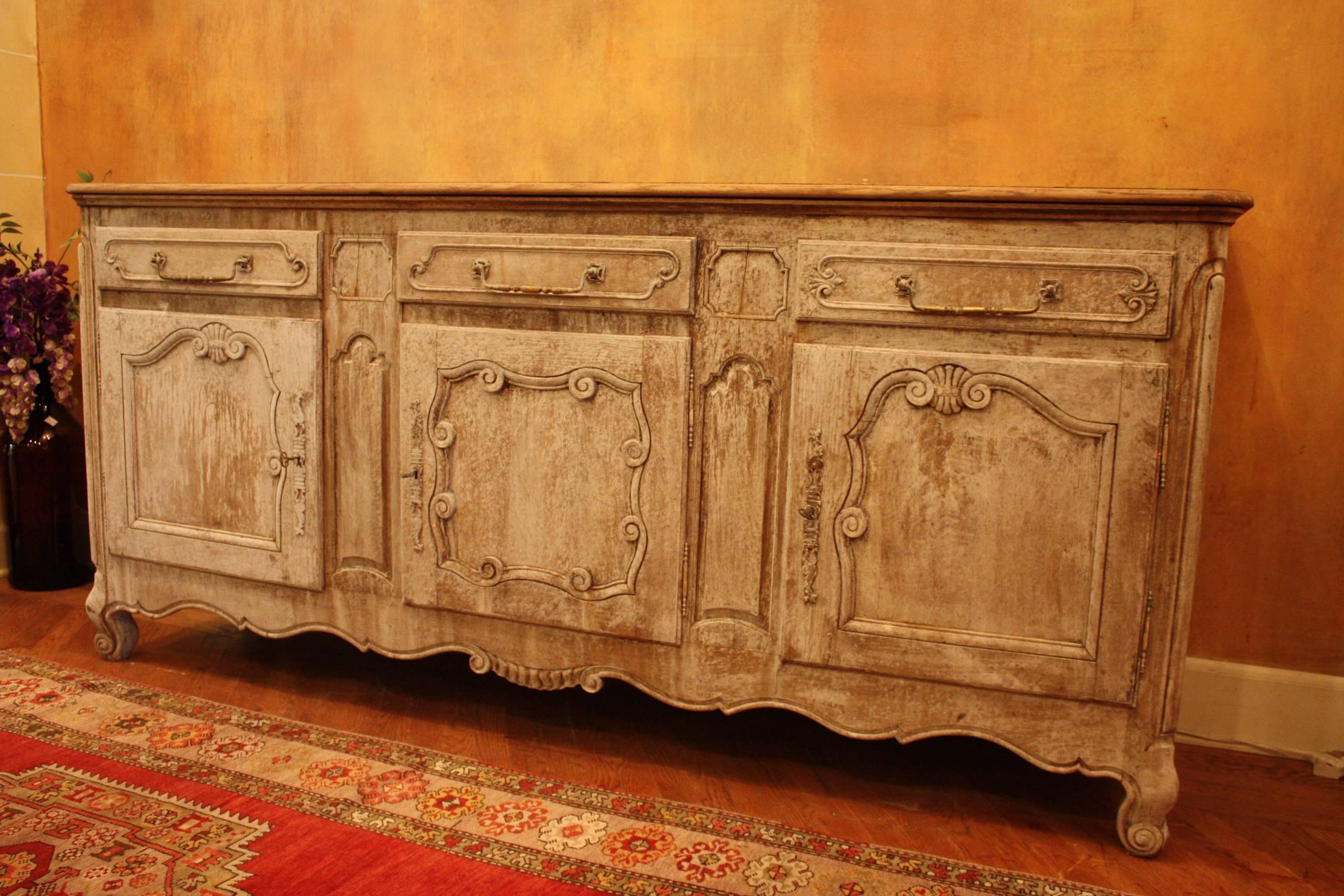 White-washed 19th century French enfilade with three doors and three drawers.
