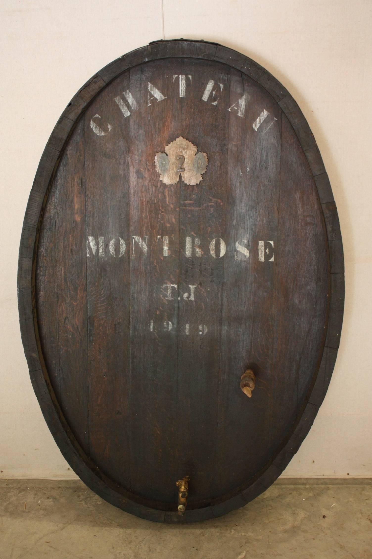 Wine barrel door that is oval in shape. This could be hung on the wall or made into an interesting coffee table.