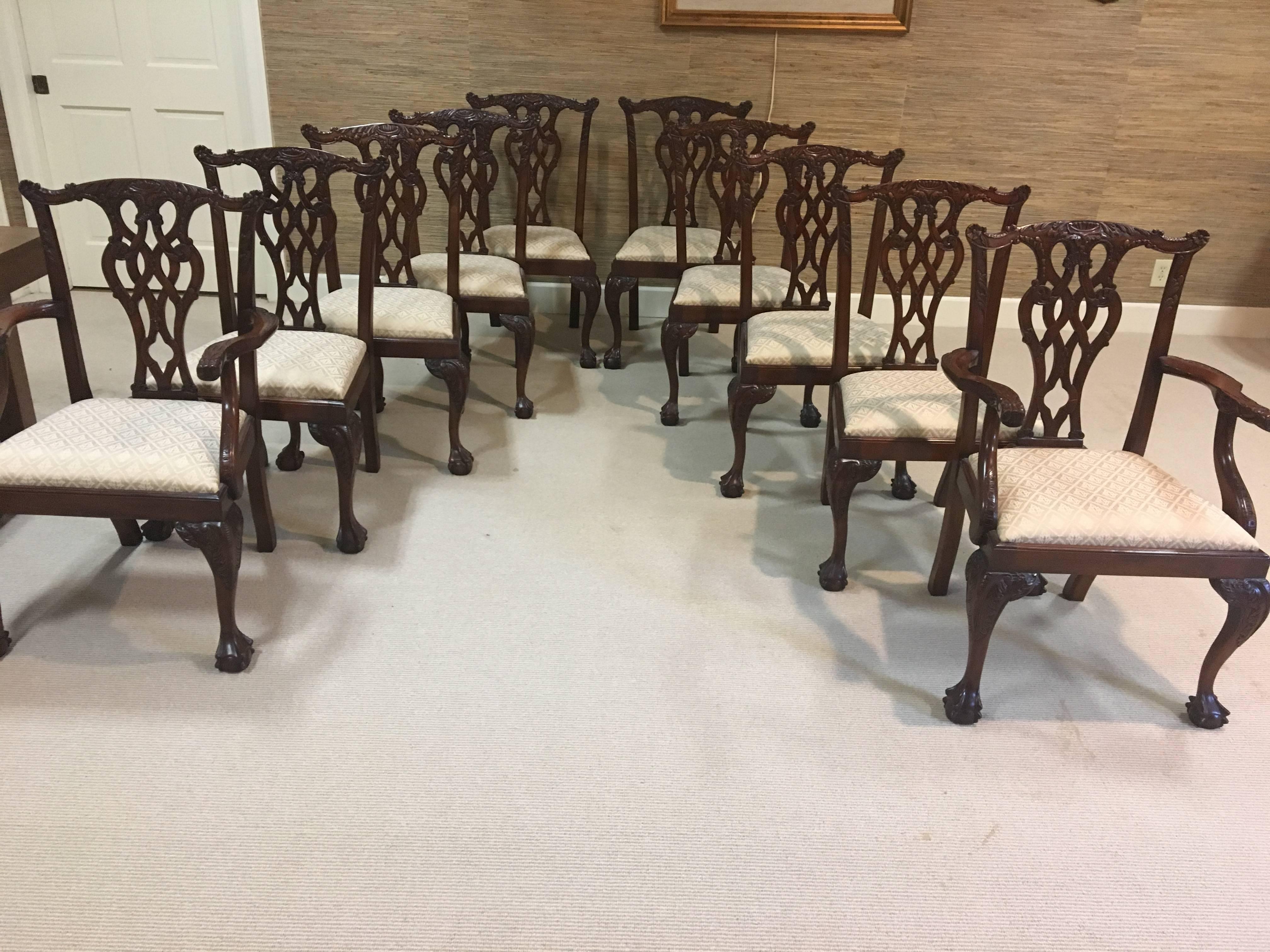 This is a very nice set of eight side and two-arm English mahogany Chippendale style dining room chairs. They are nicely carved and beautifully upholstered. They are in fantastic condition.