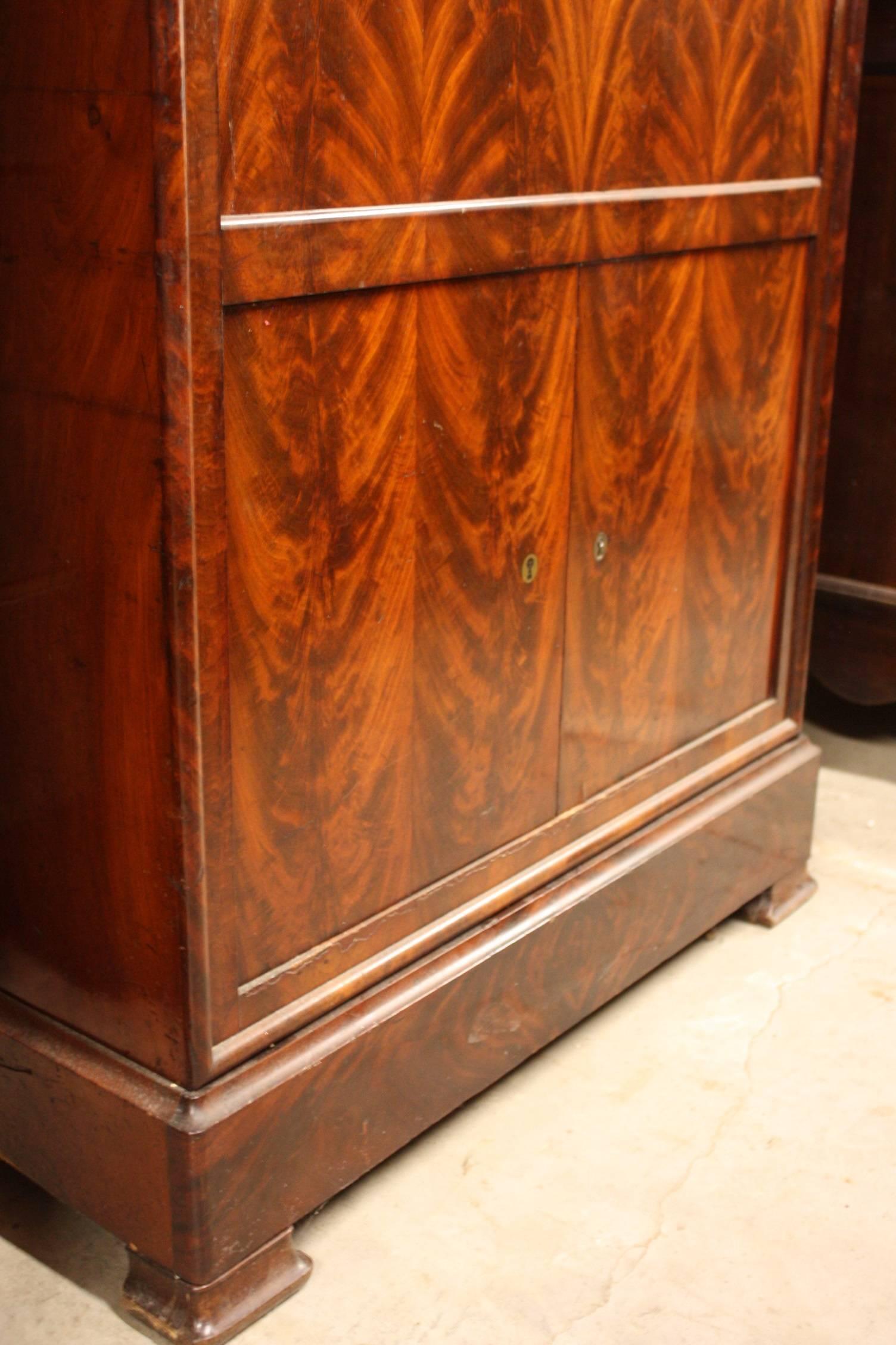 French Empire style mahogany secretary with marble top has lower cabinets which are lockable (key included) and the single hidden drawer at the top. The interior has document and accessory storage drawers.